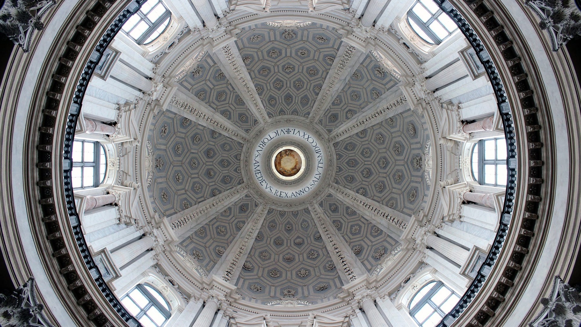 Interior of a grand dome with ornate carvings and windows HD Wallpaper