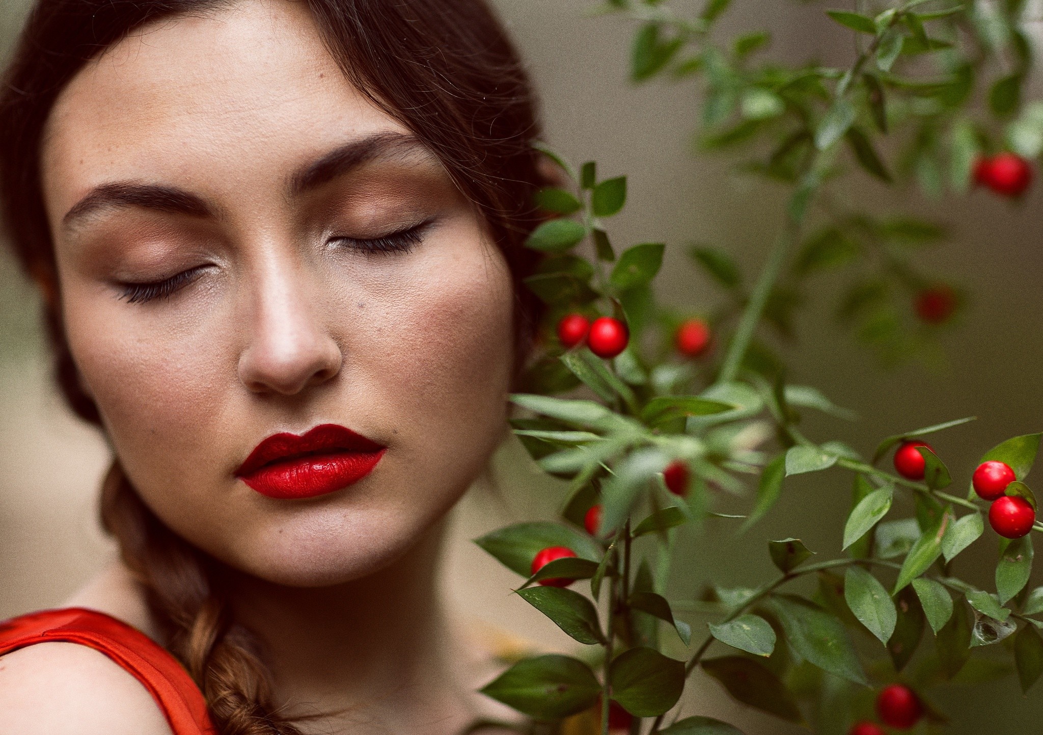 Woman with red lipstick and closed eyes near red berries HD Wallpaper