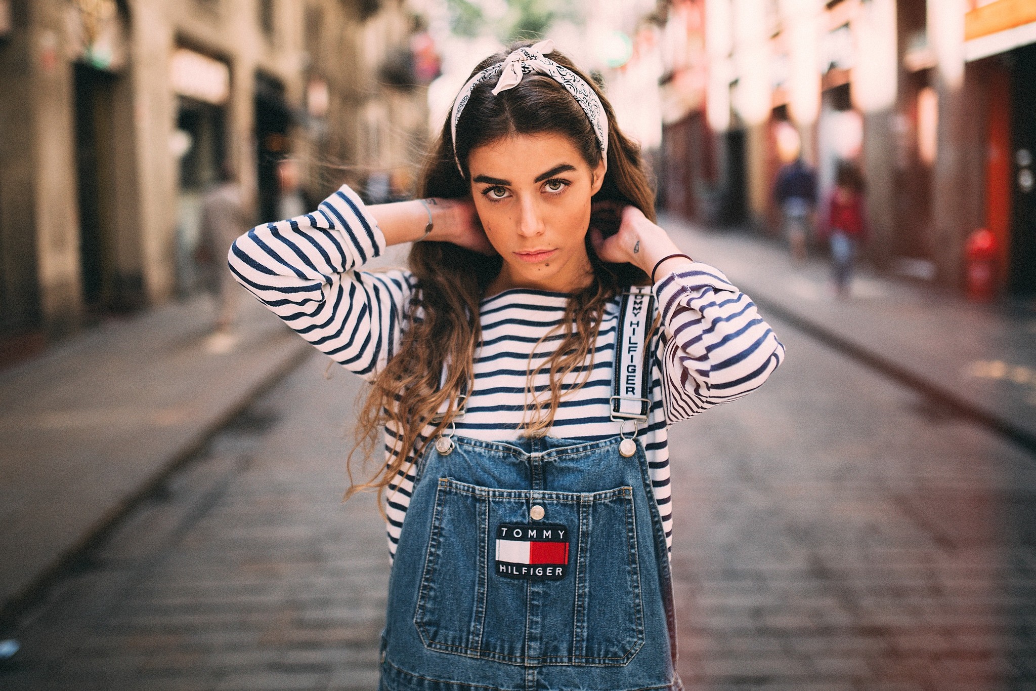 Woman wearing Tommy Hilfiger overalls and striped shirt with headband HD Wallpaper
