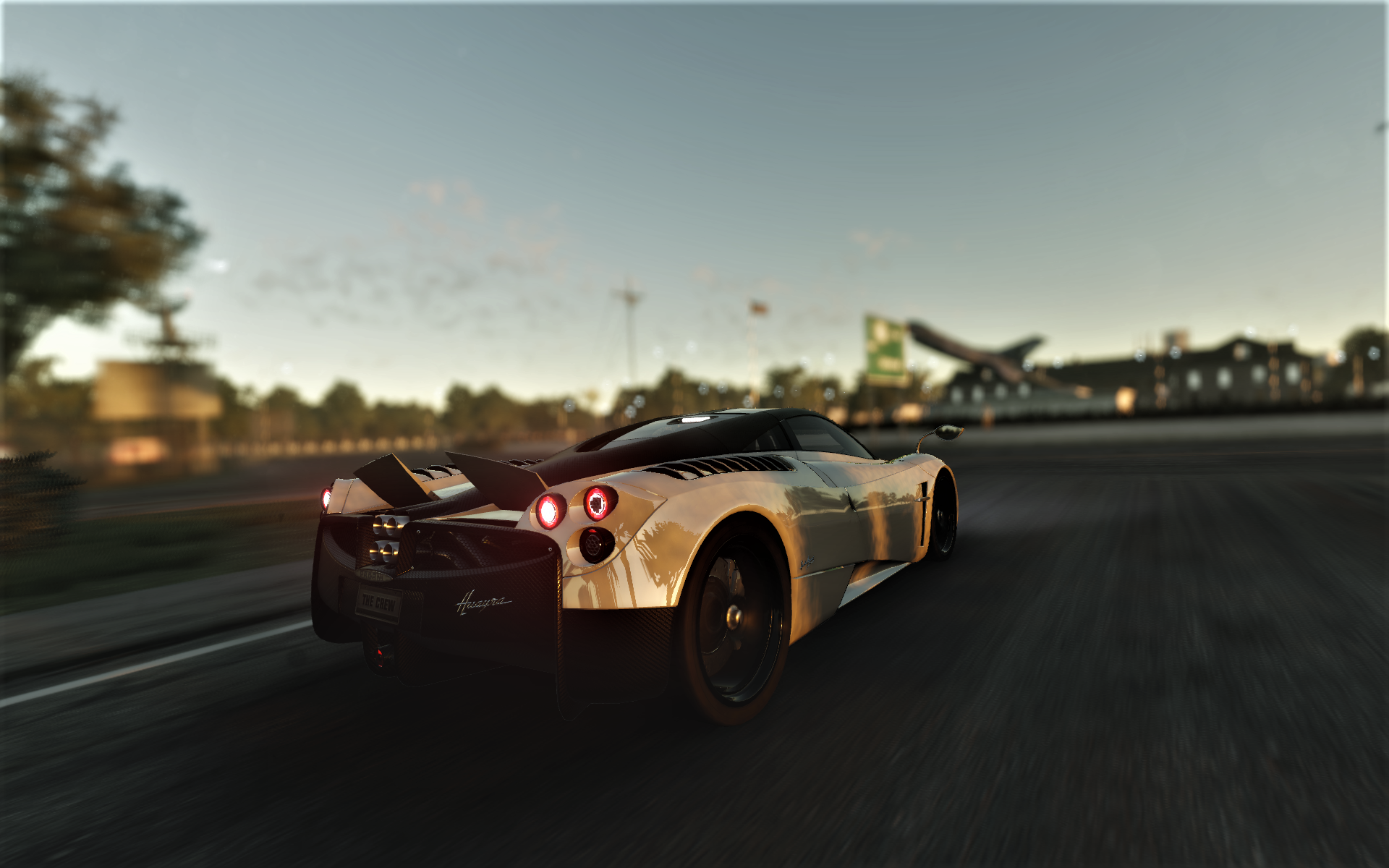 Pagani Huayra driving on a road HD Wallpaper