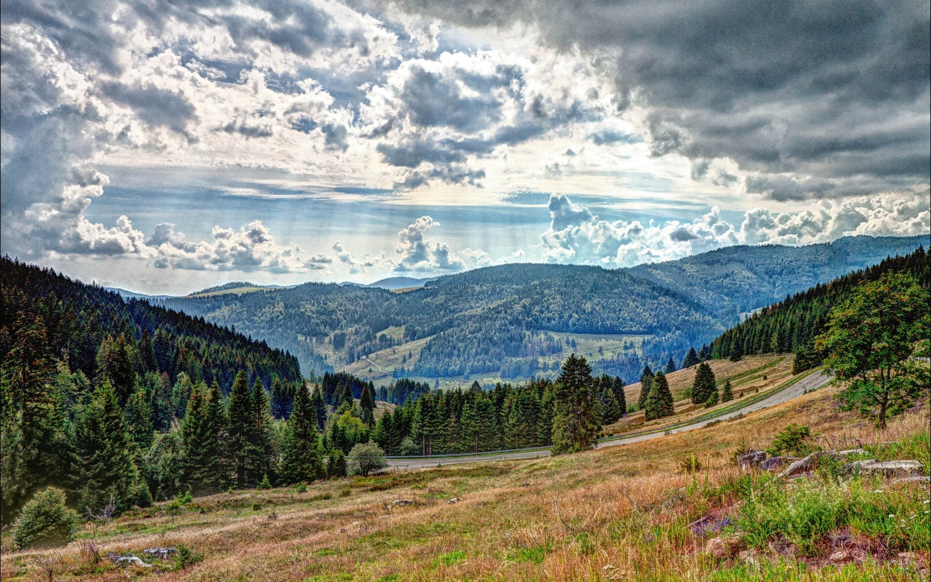 Mountain landscape with rolling hills and forests HD Wallpaper