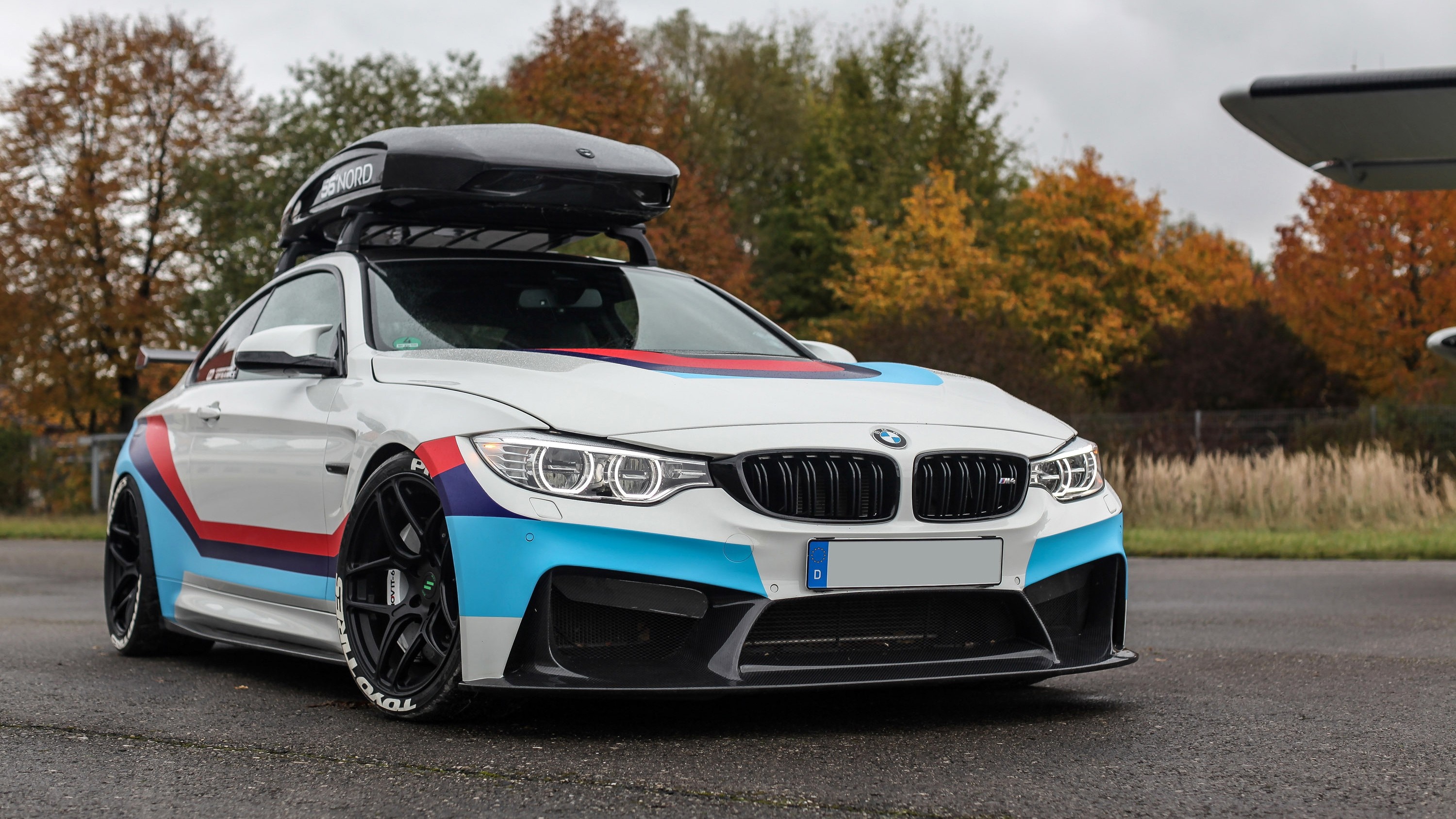White BMW M4 Coupe with Roof Box and Racing Stripes HD Wallpaper