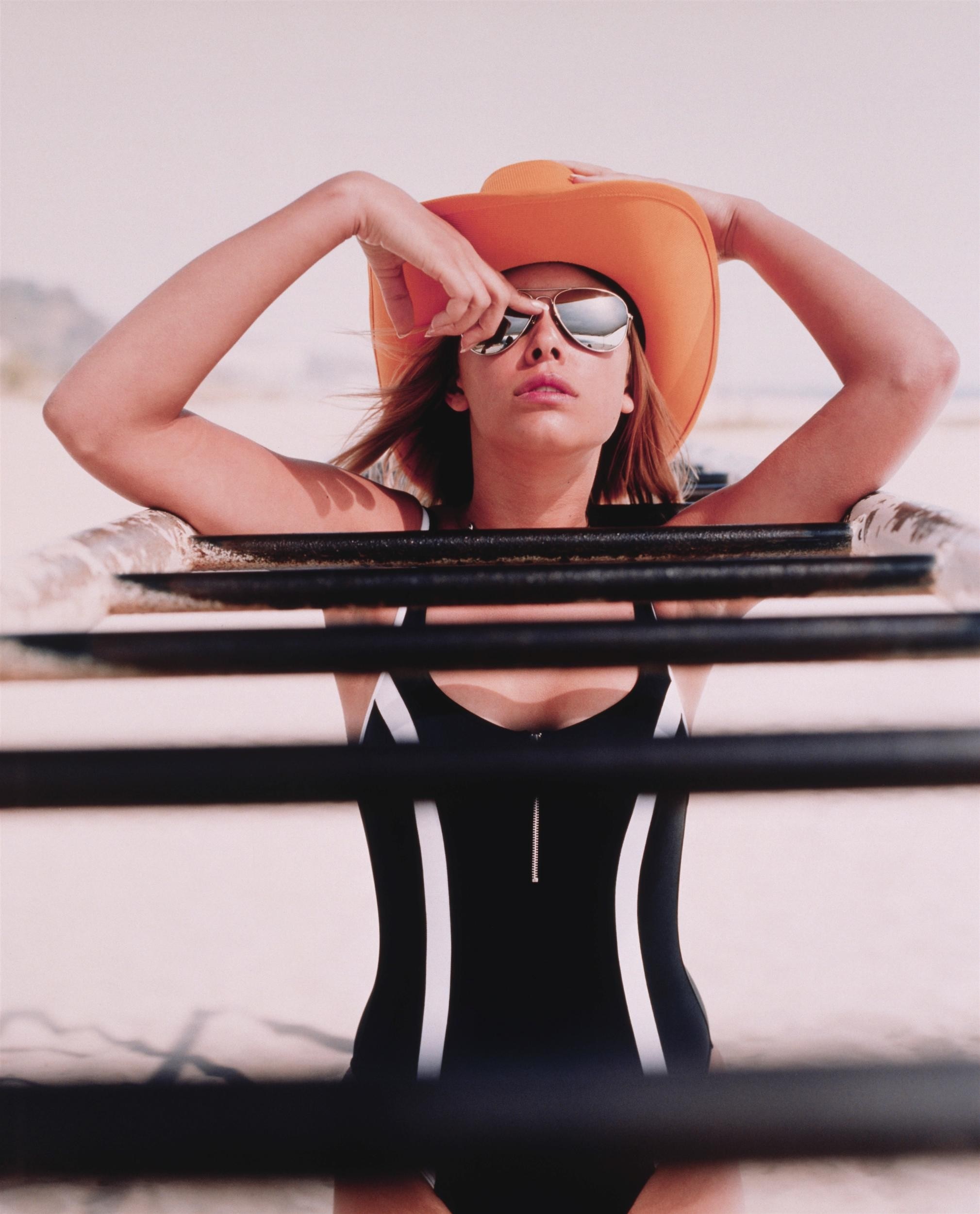 Woman in swimsuit and hat at the beach HD Wallpaper