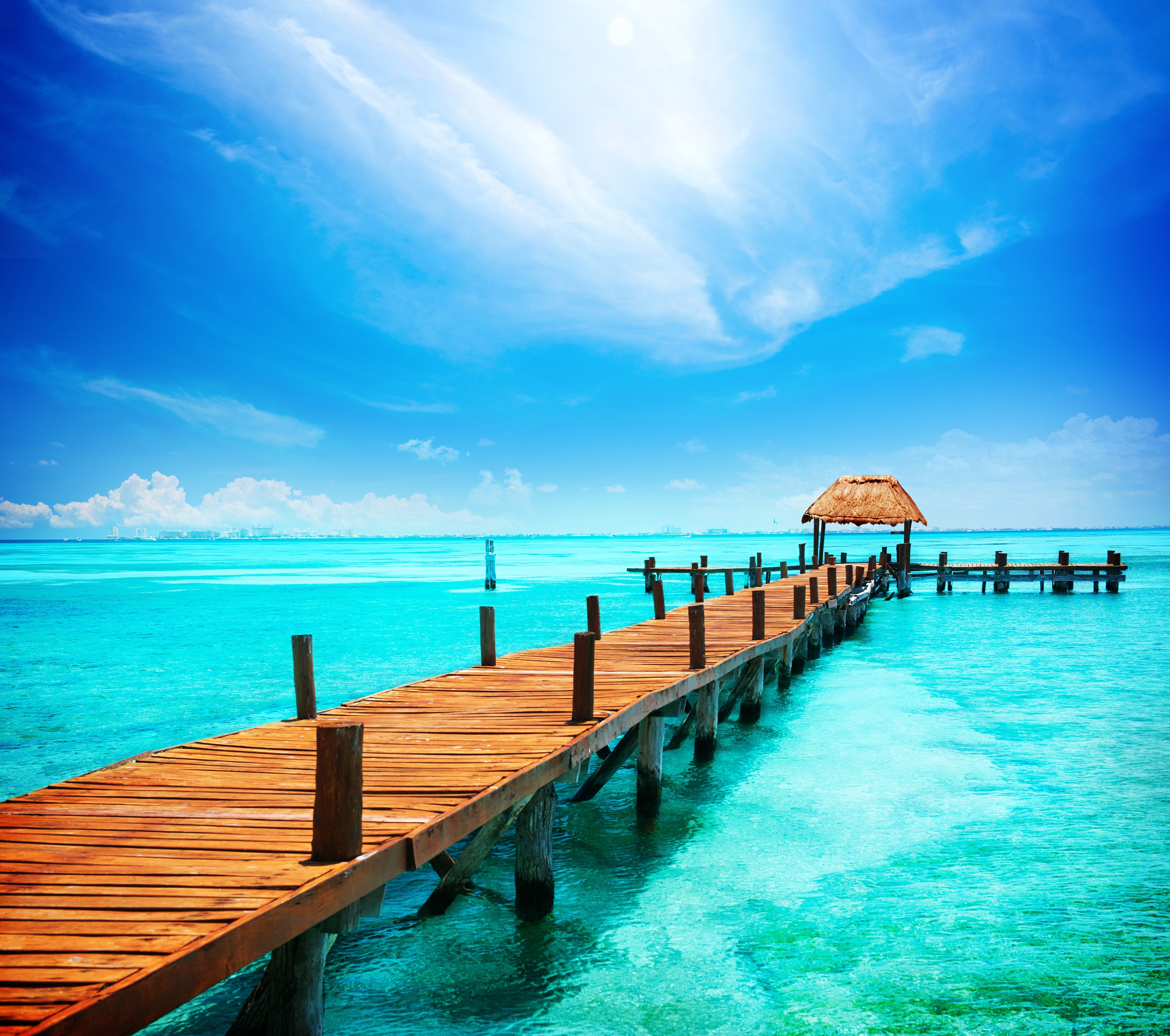 Wooden pier with thatched hut over turquoise ocean HD Wallpaper