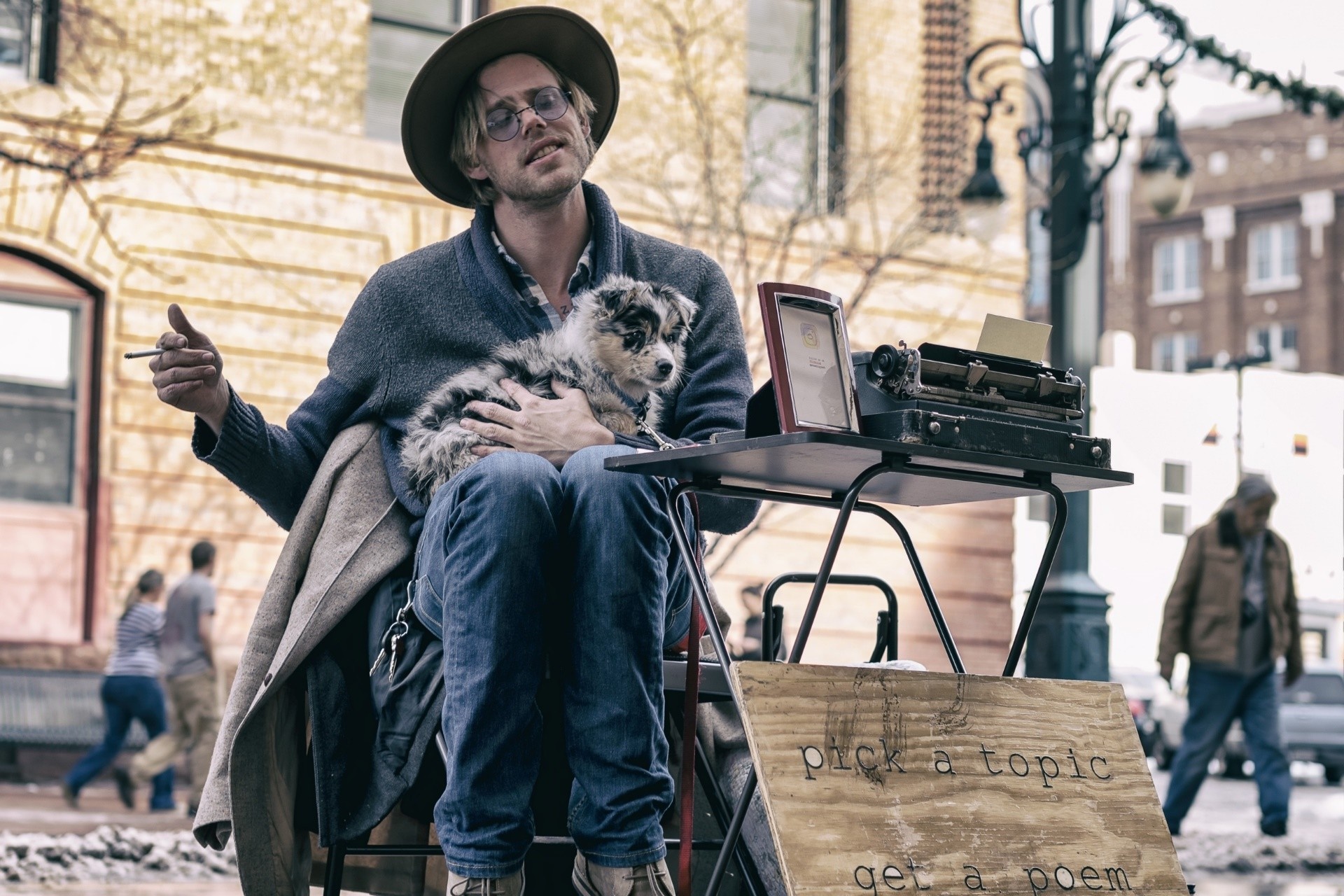 Man with dog and typewriter on street HD Wallpaper