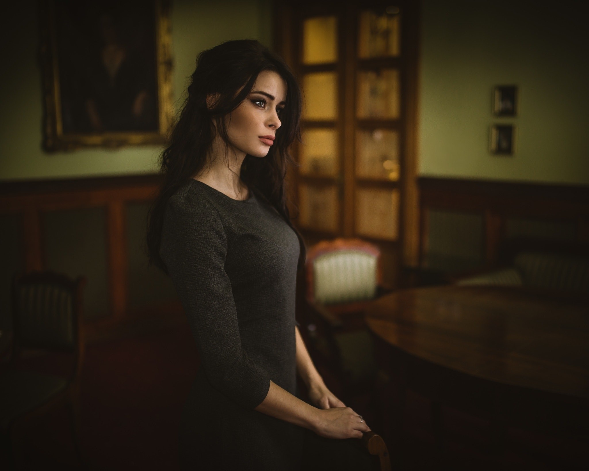 Woman in dark dress in a room HD Wallpaper