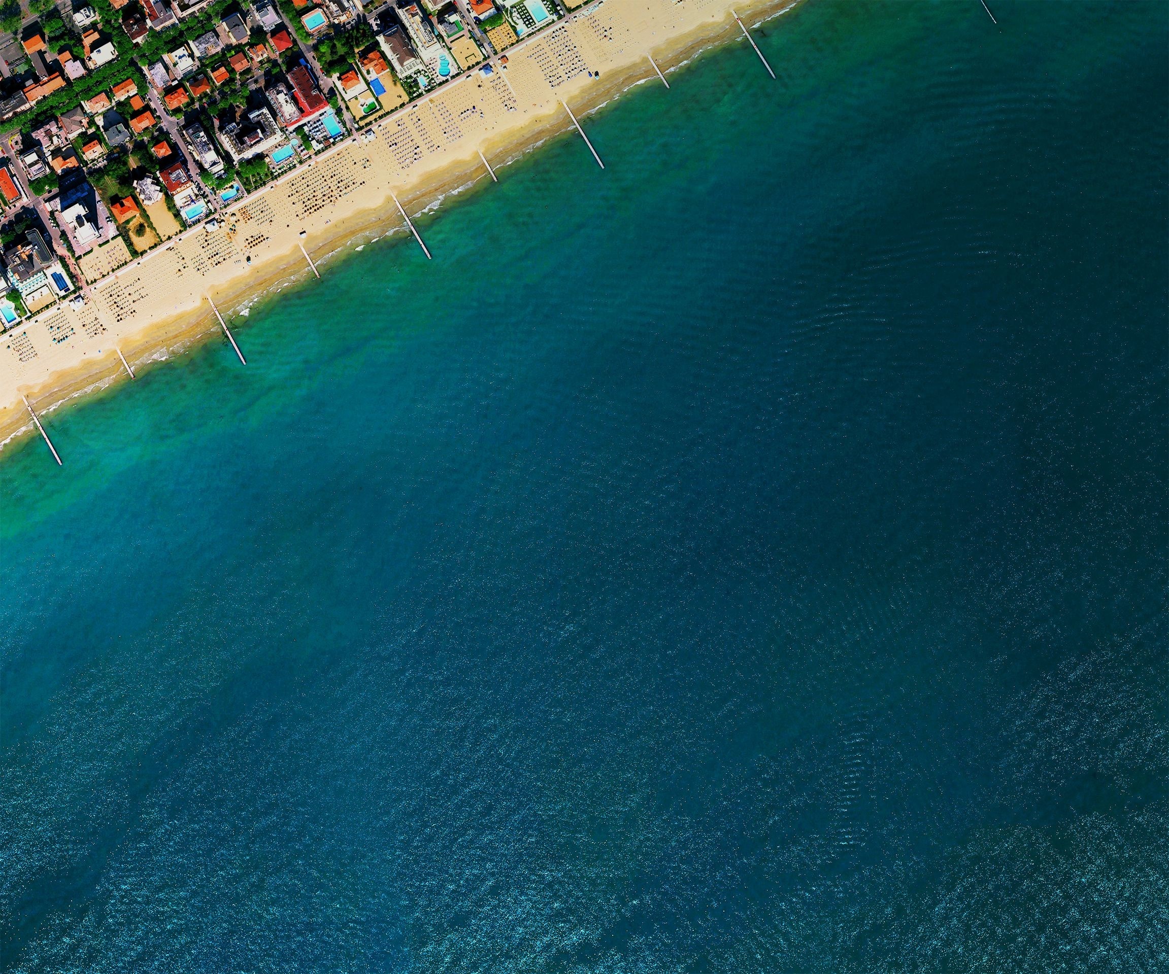 Aerial view of a beach resort town and the ocean HD Wallpaper