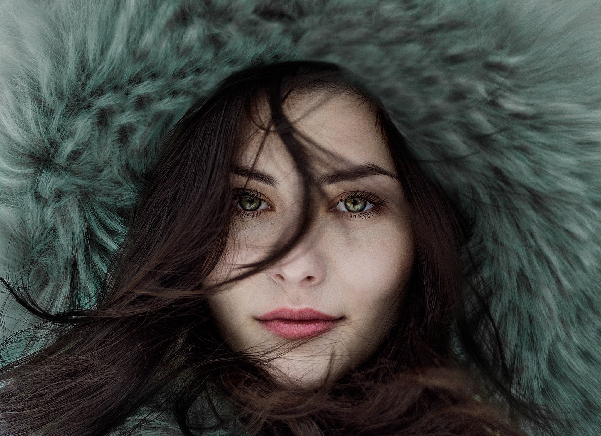 Woman with brown hair and green eyes in fur hood HD Wallpaper