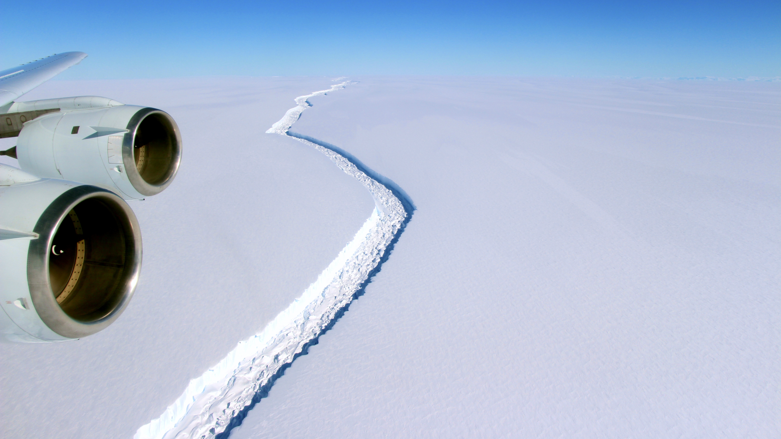 Airplane engines over a glacial crevasse HD Wallpaper
