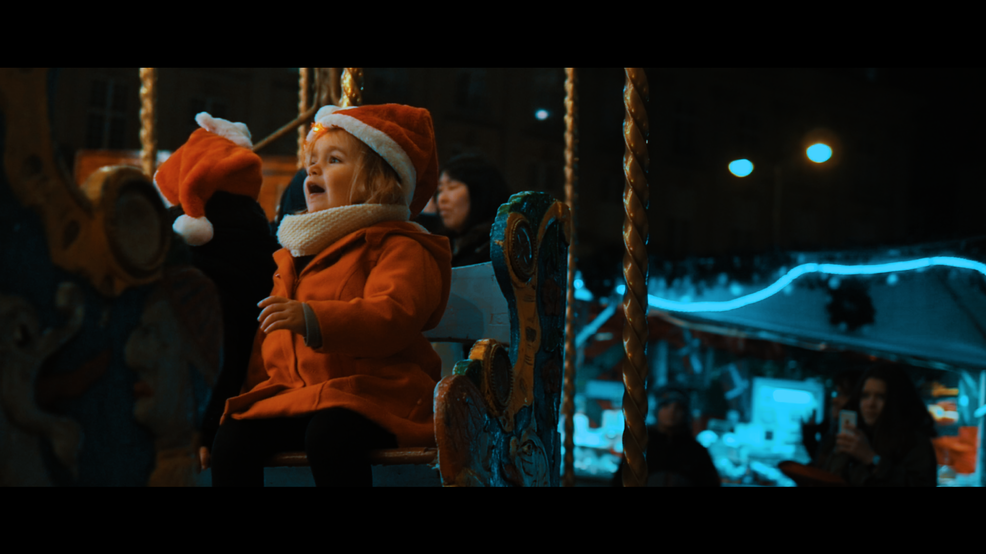 Girl in Santa hat on a carousel at night HD Wallpaper