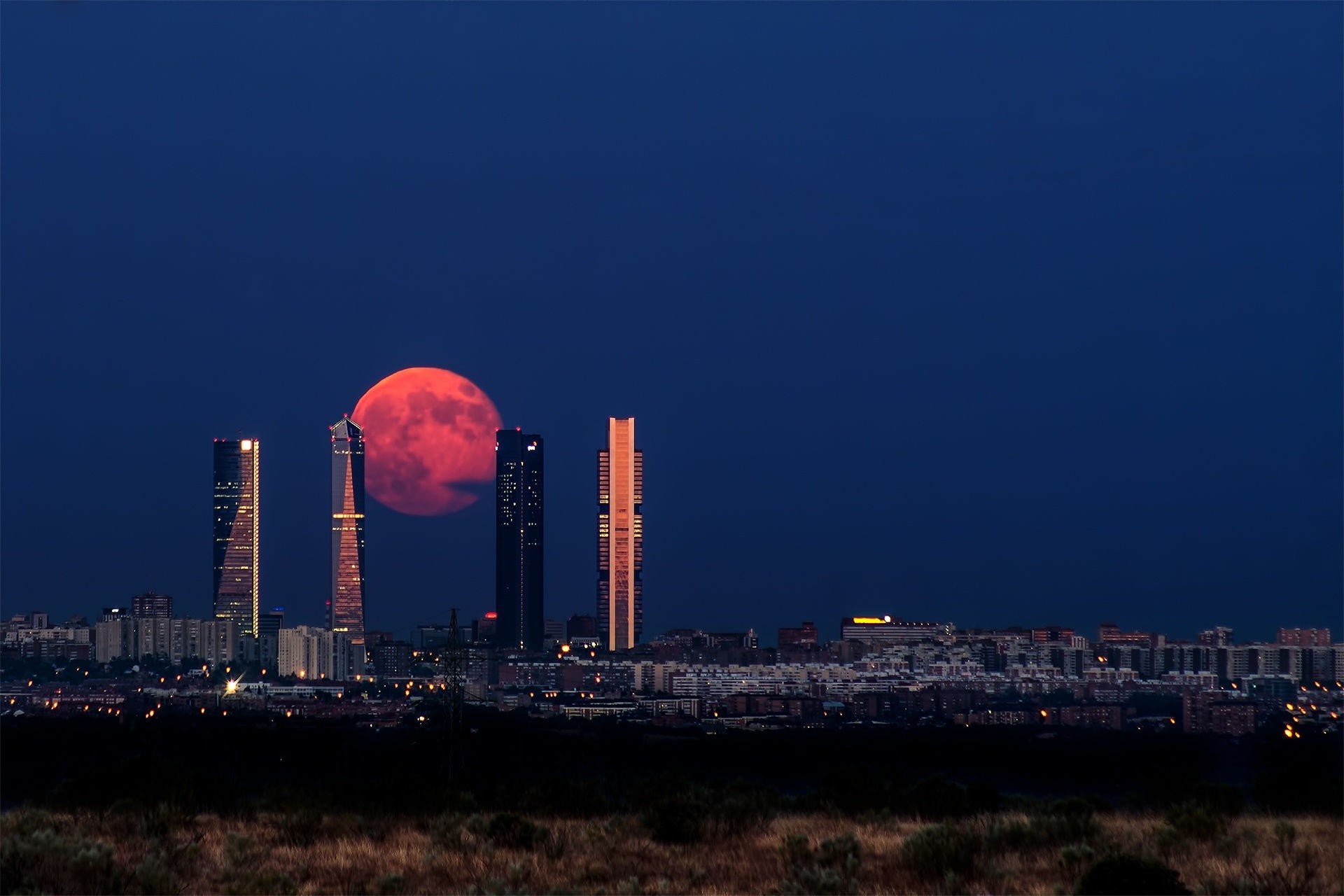 Red Moon over Madrid Skyline with Skyscrapers HD Wallpaper