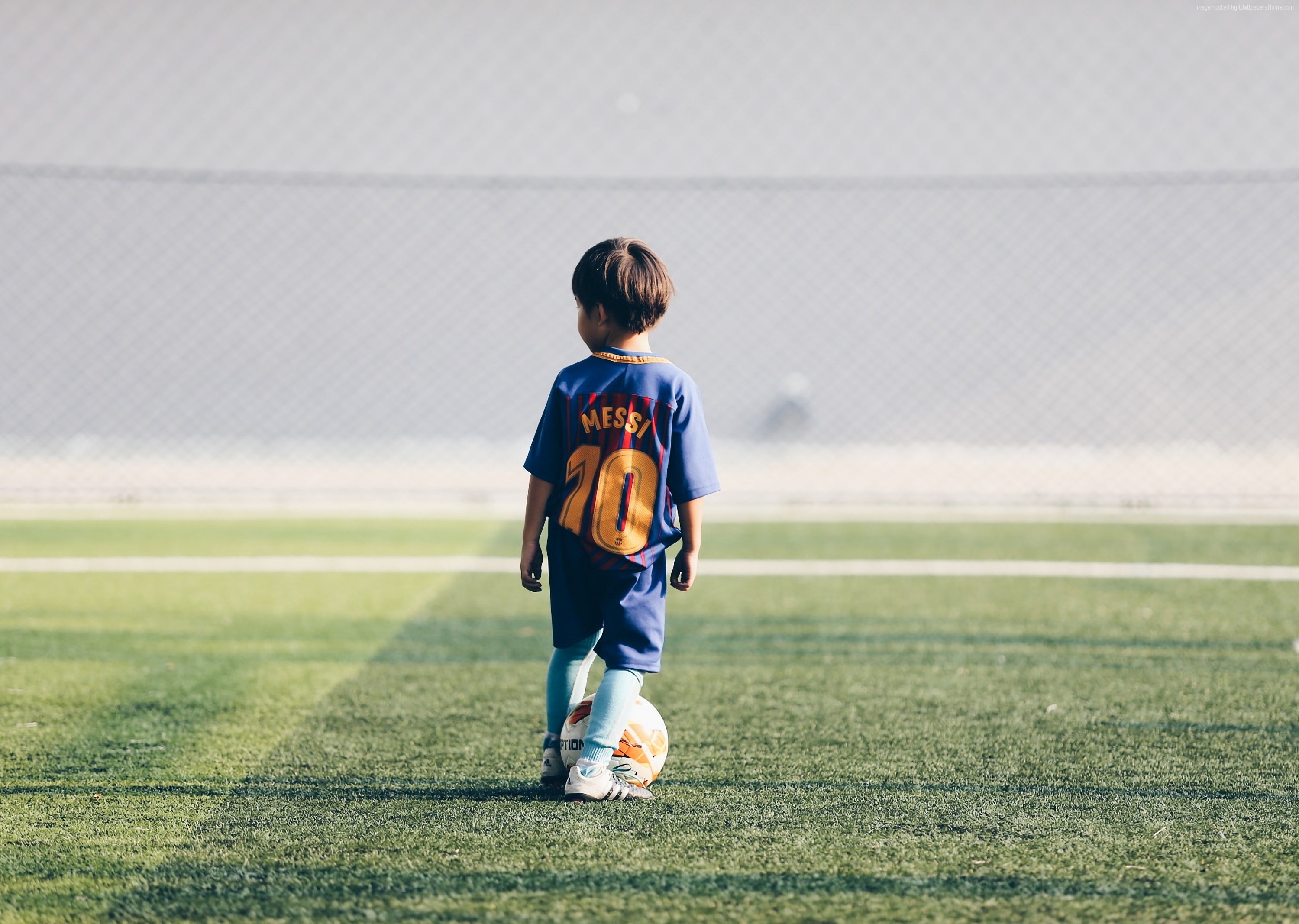 Child in Messi Soccer Jersey on Field HD Wallpaper