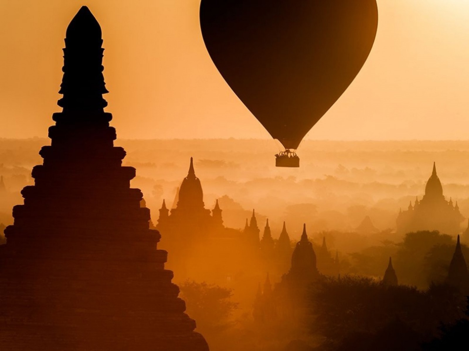 Hot air balloon over ancient temples at sunrise HD Wallpaper