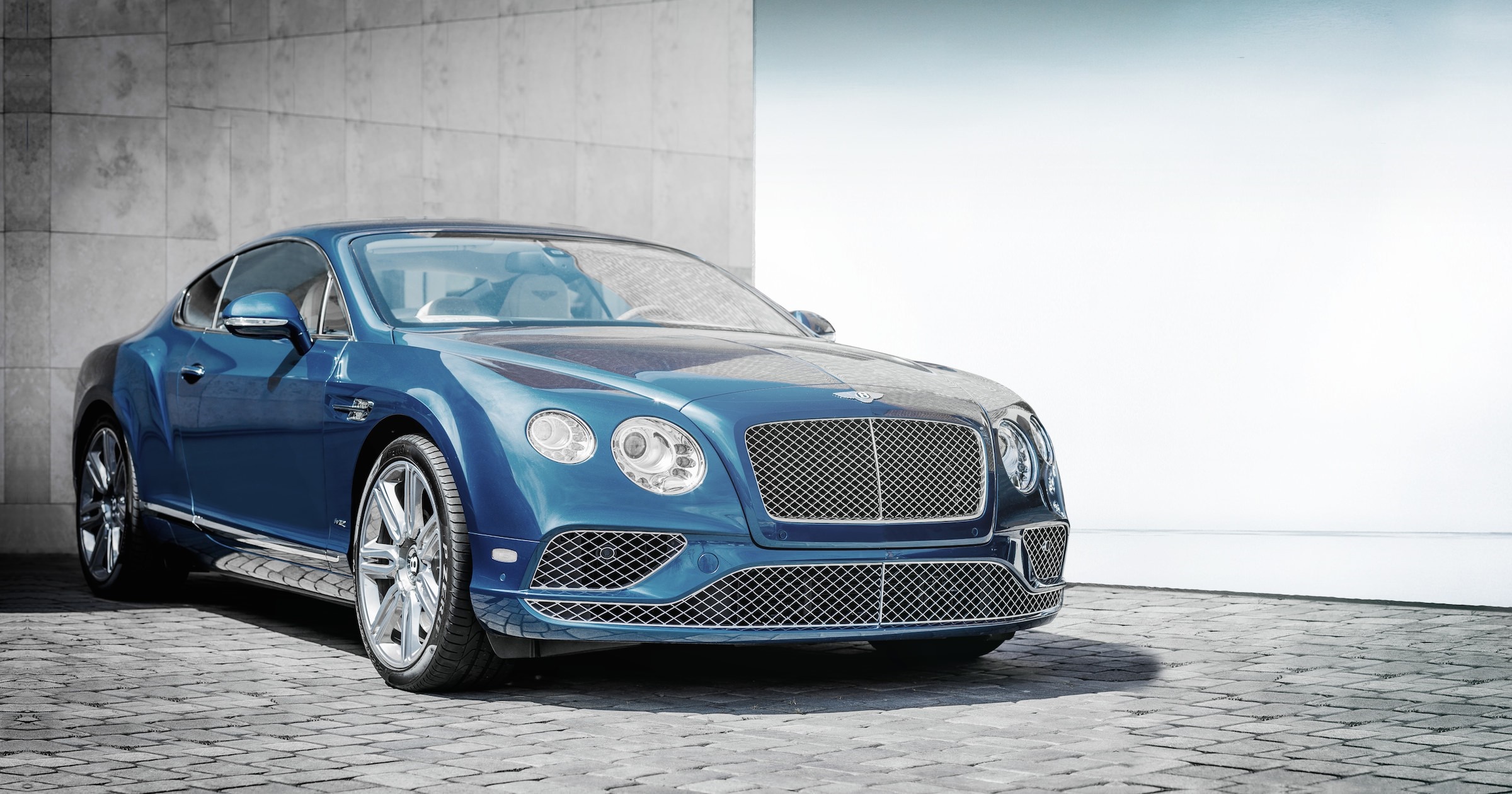 Blue Bentley Continental GT parked on cobblestone HD Wallpaper