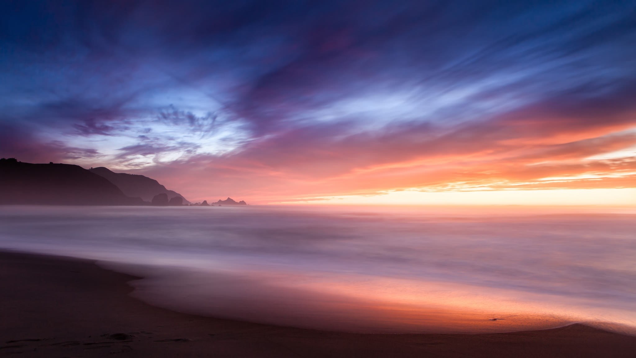 Sunset over the ocean with colorful clouds and waves HD Wallpaper