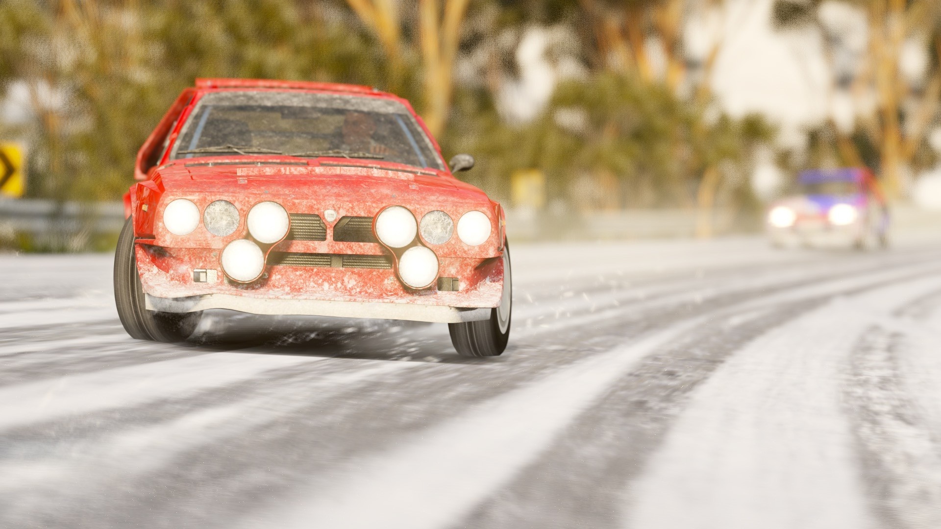 Red Lancia Delta Integrale rally car on a snowy road HD Wallpaper