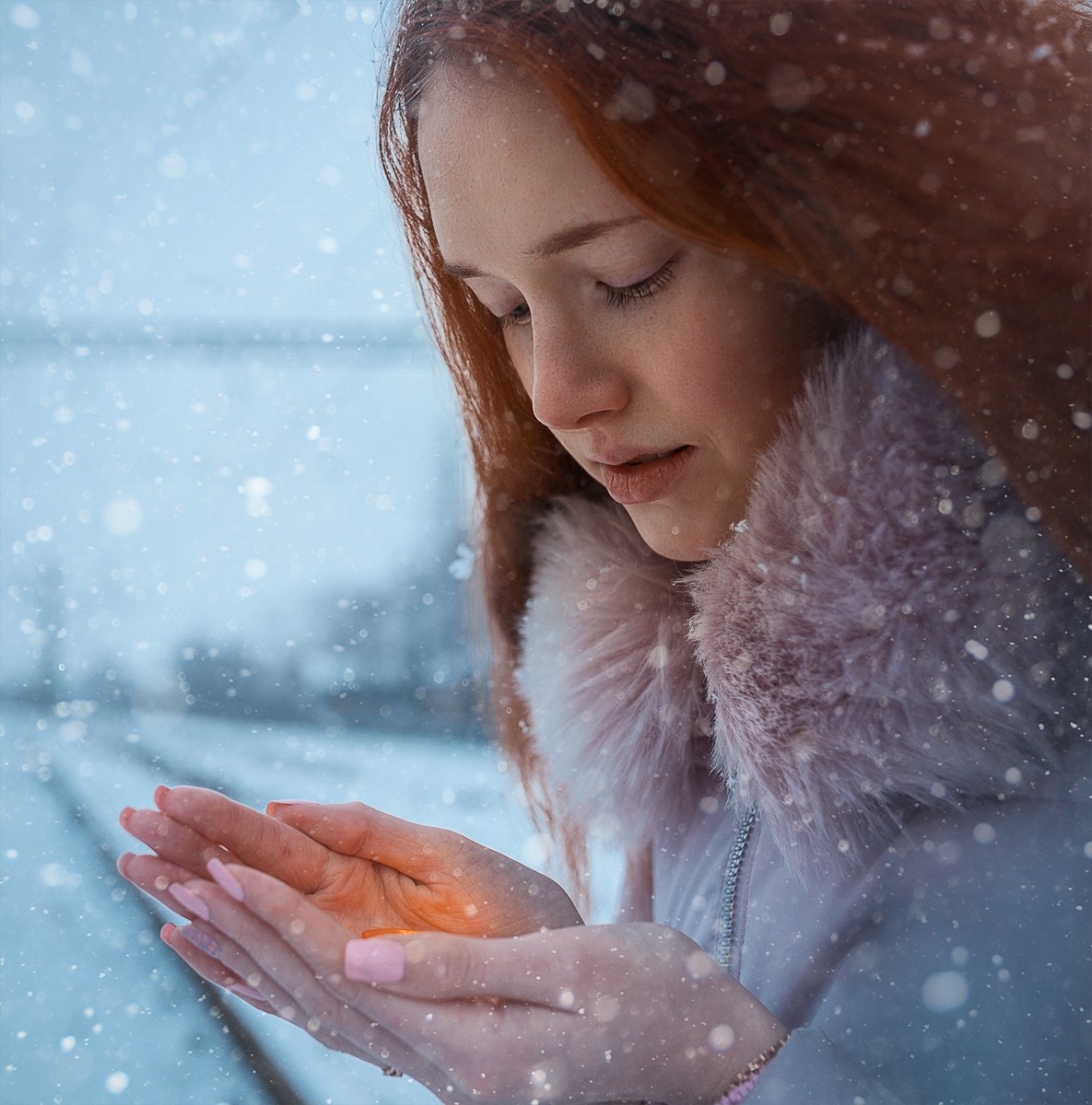 Woman with red hair in the snow holding light HD Wallpaper