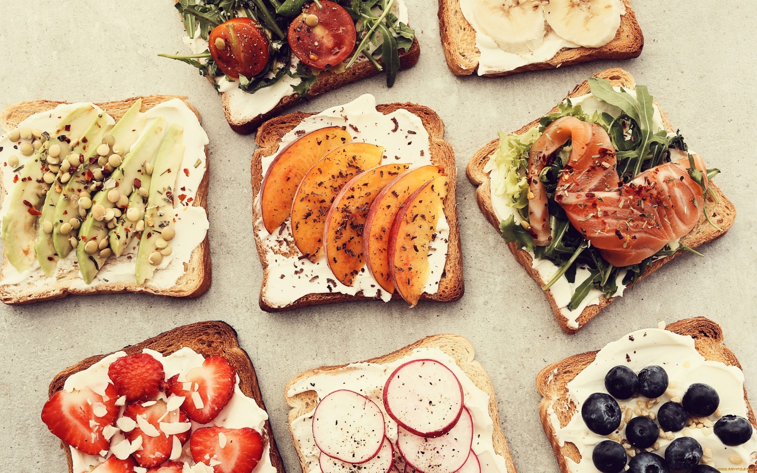 Assortment of open-faced sandwiches with various toppings HD Wallpaper