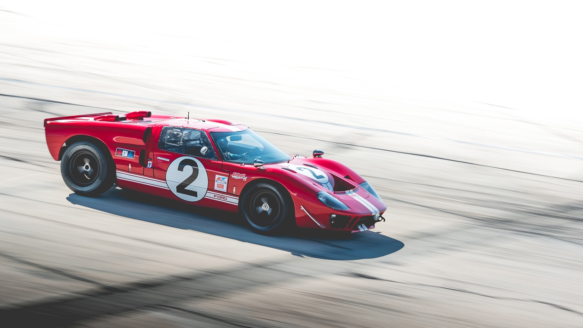 Red Ford GT40 race car with number 2 on a race track HD Wallpaper