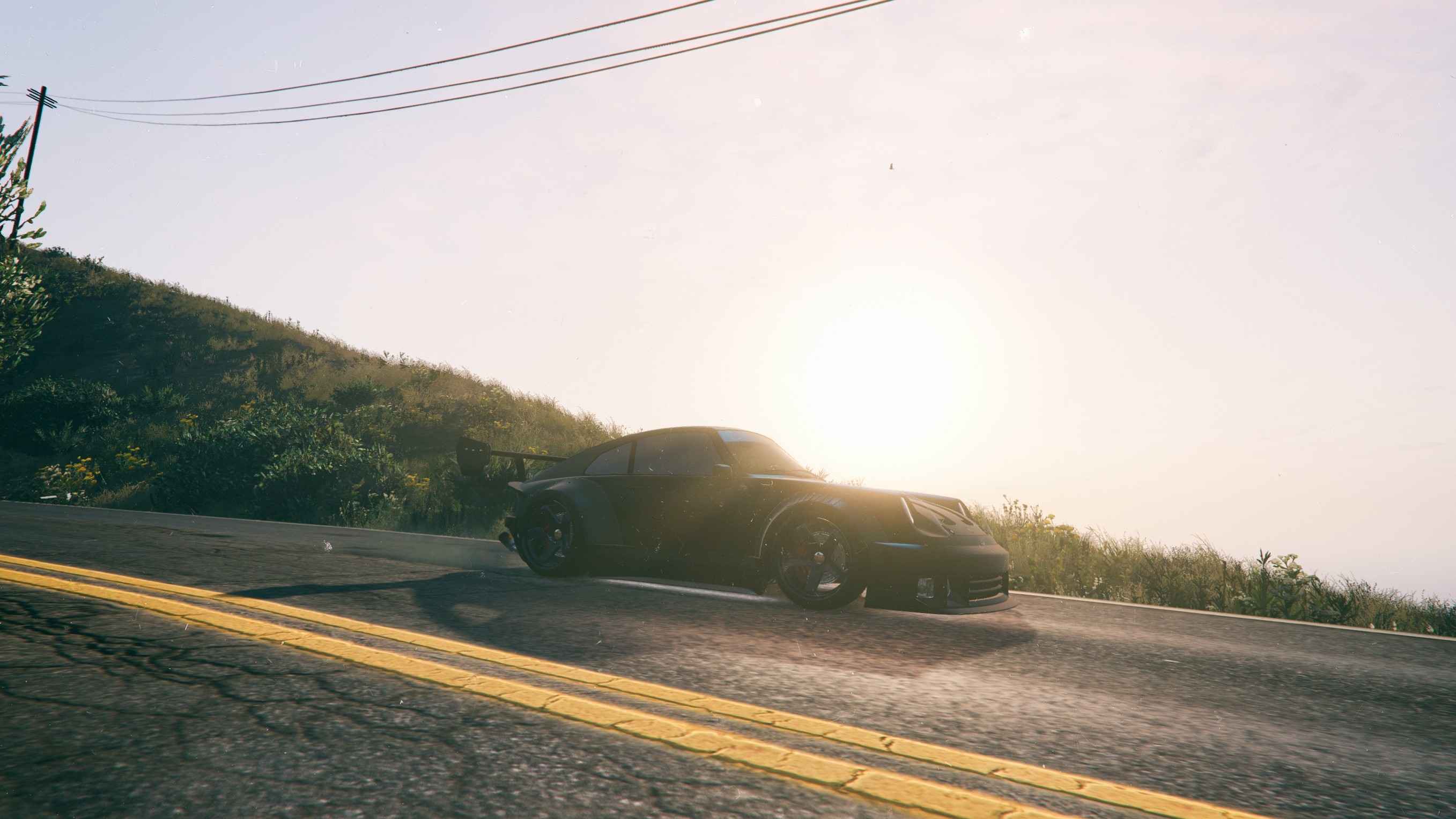 Black Porsche 911 GT2 RS on a coastal road at sunrise HD Wallpaper