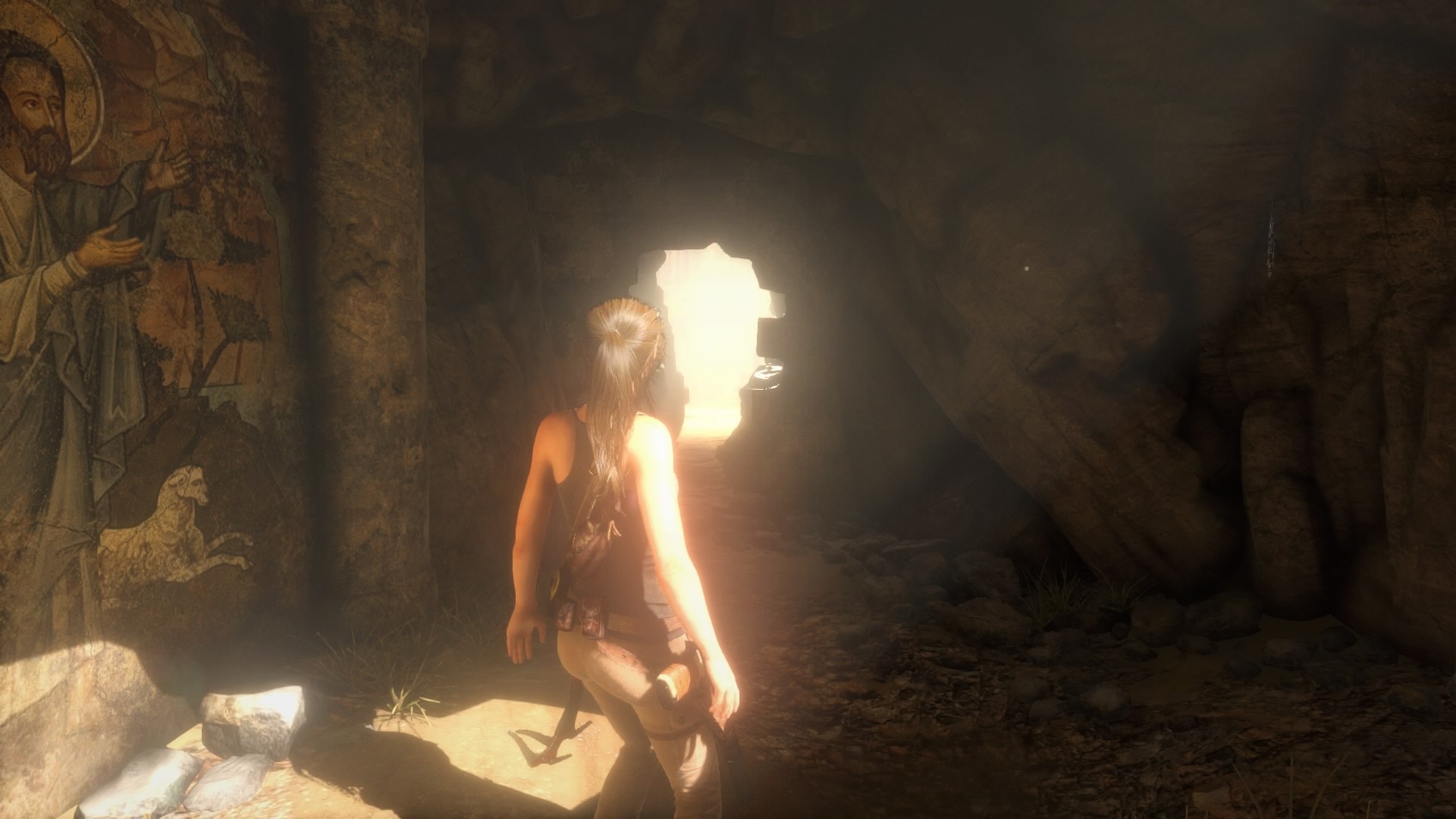 Lara Croft from Tomb Raider in a cave with ancient art HD Wallpaper