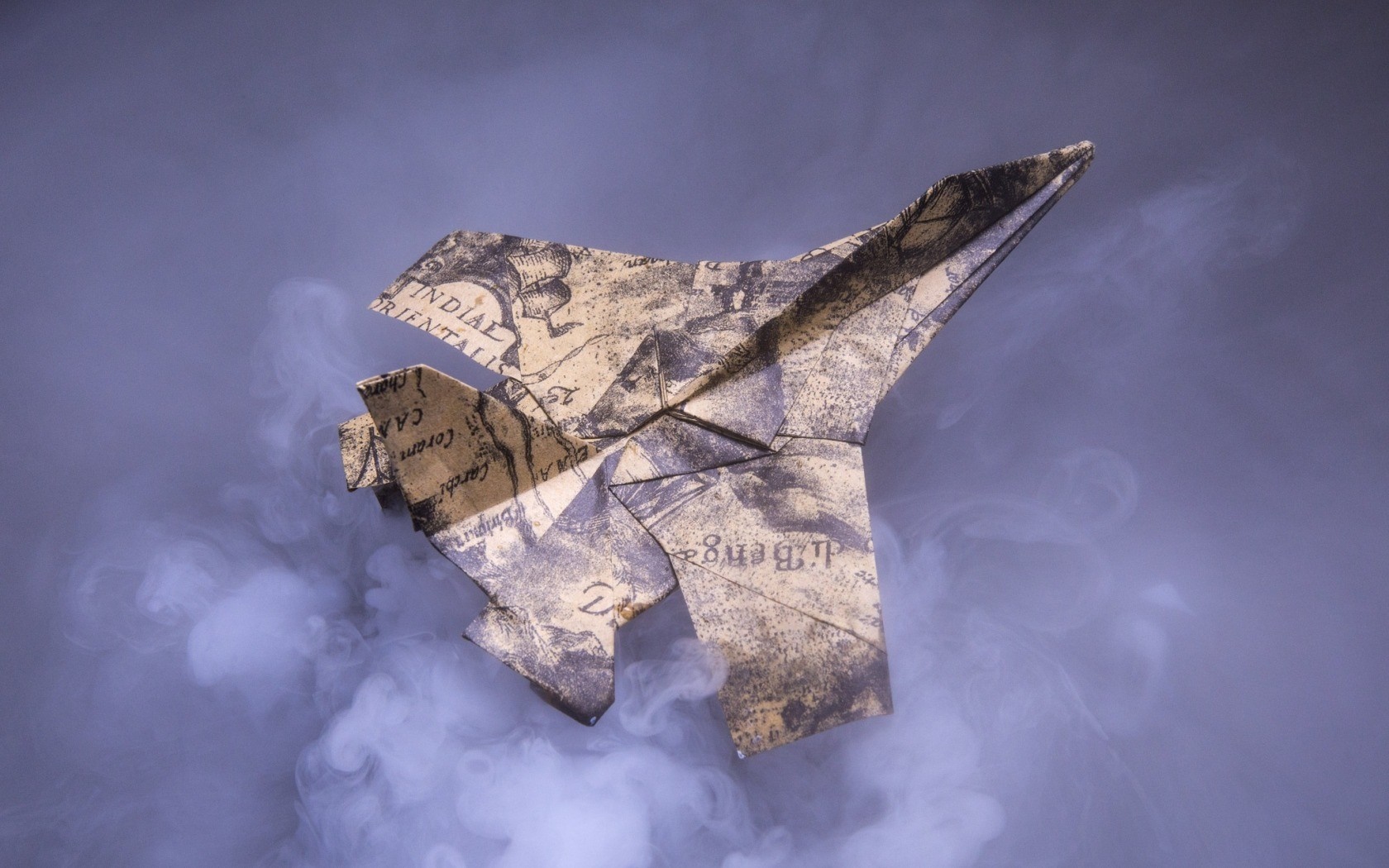 Origami airplane made of old map paper in smoke HD Wallpaper