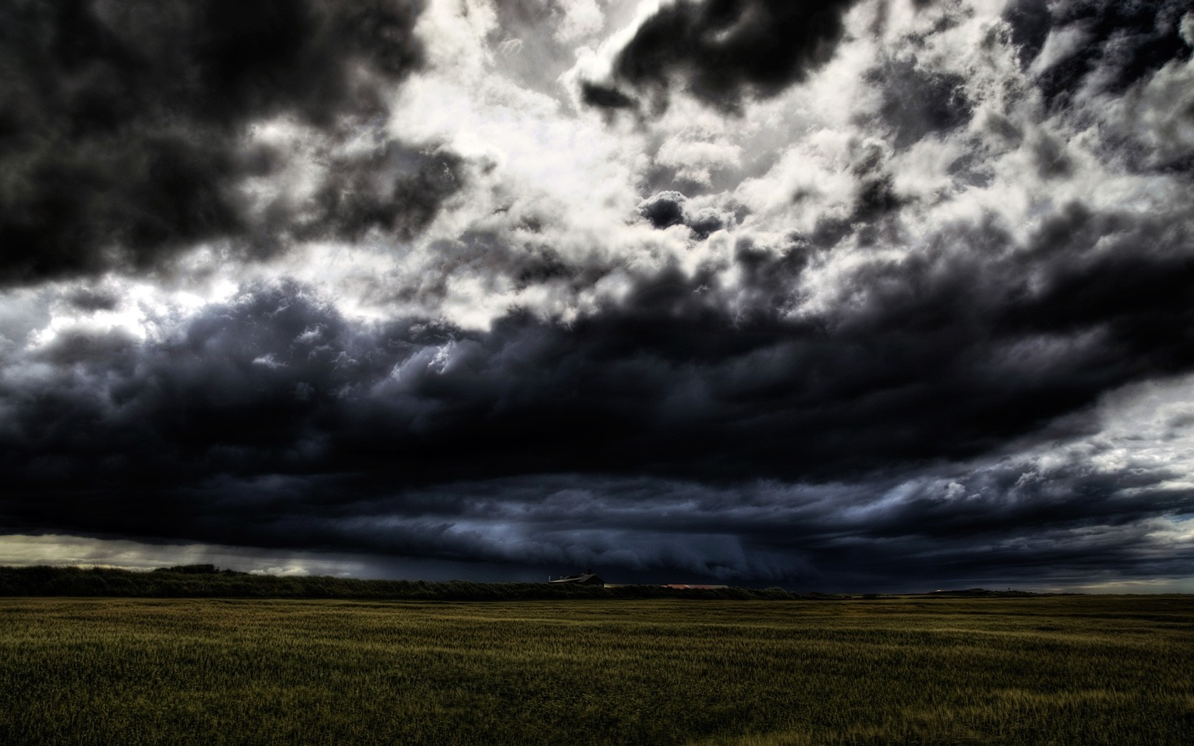 Dark storm clouds over a field HD Wallpaper
