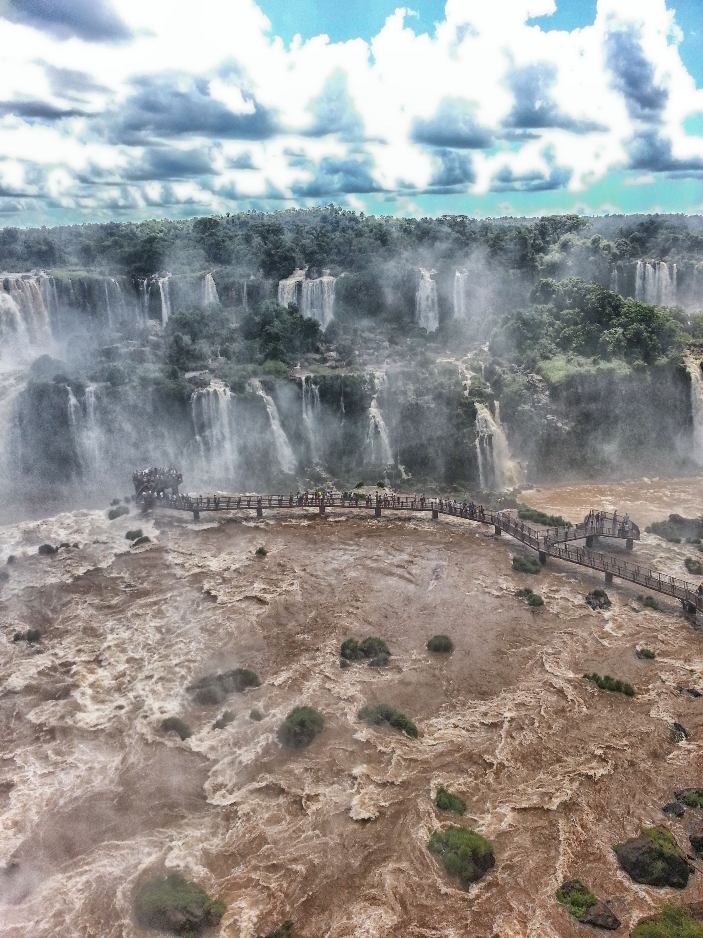 Iguazu Falls with a wooden walkway and tourists HD Wallpaper