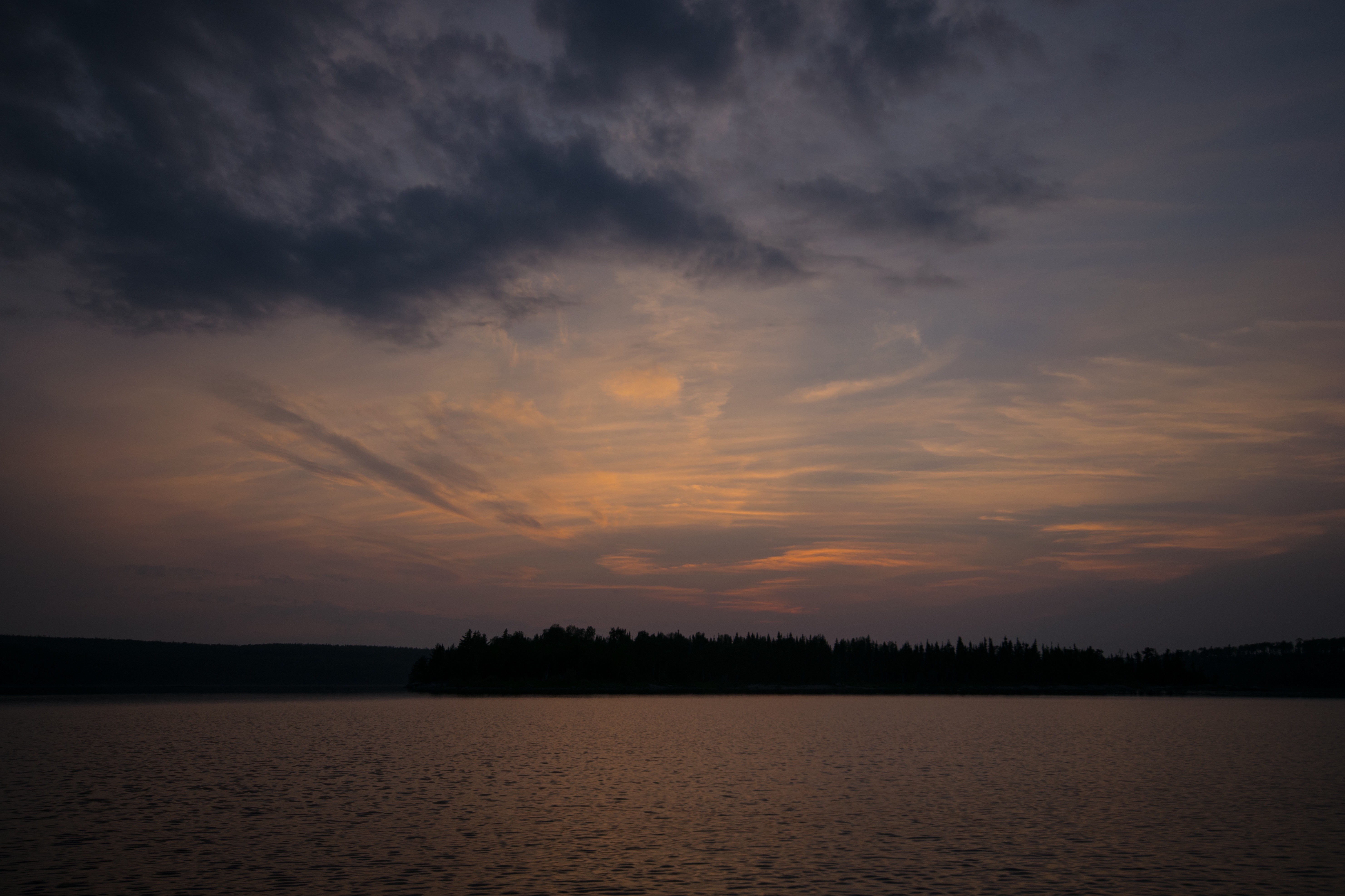 Sunset over a lake with a forest silhouette HD Wallpaper
