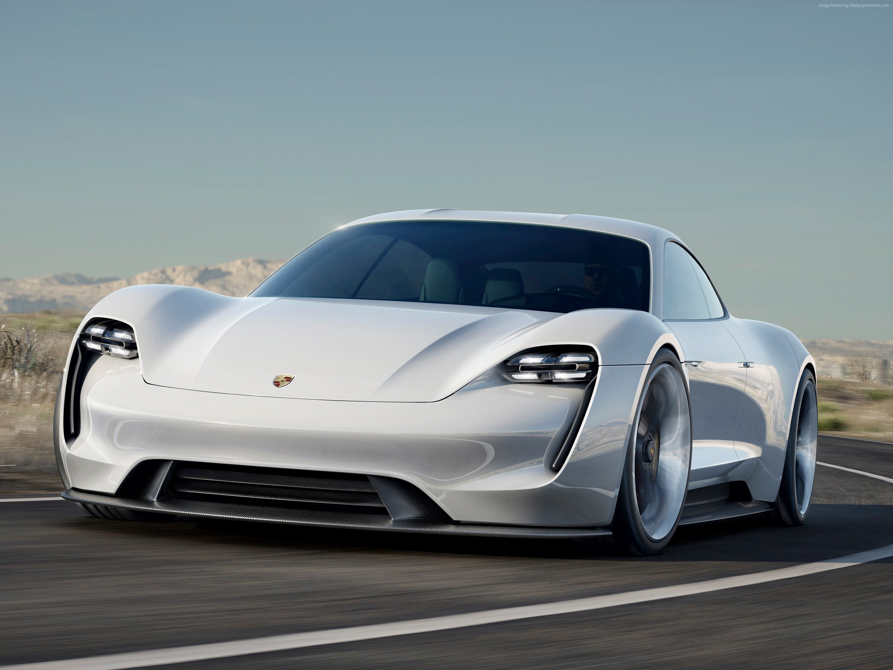 White Porsche Taycan driving on a road HD Wallpaper