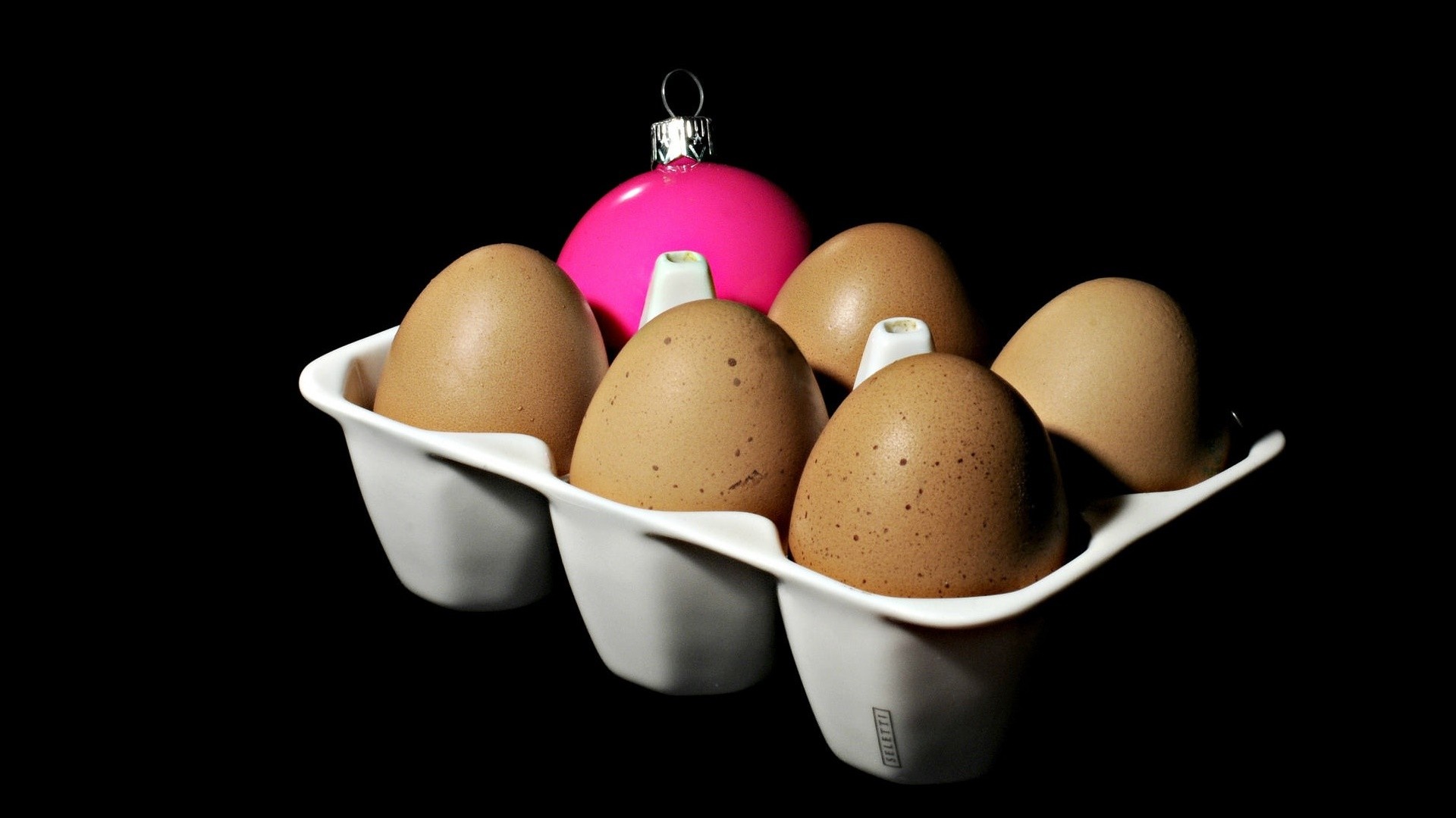 Eggs and a pink Christmas ornament in an egg carton HD Wallpaper