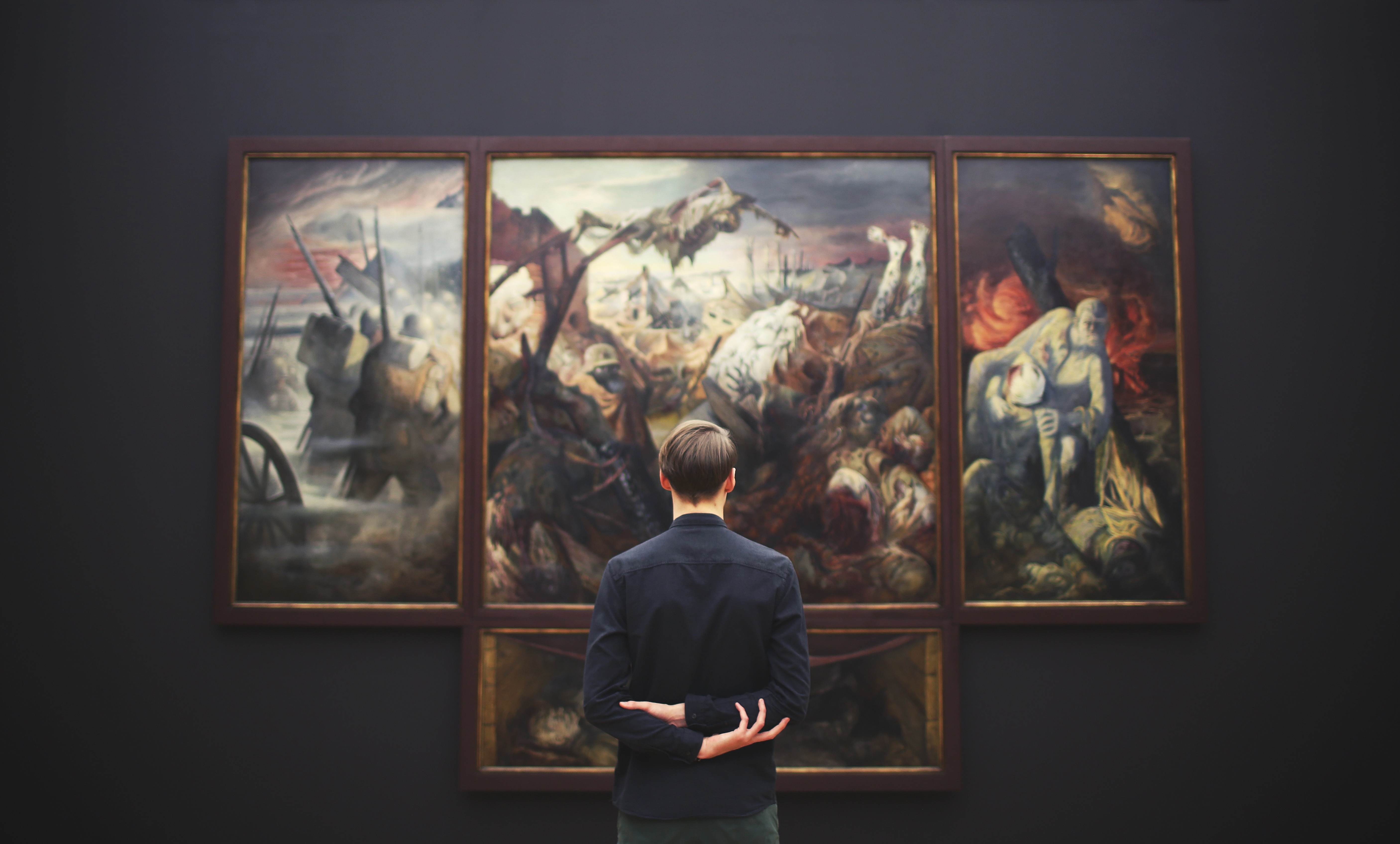 Man viewing a triptych painting in an art gallery HD Wallpaper