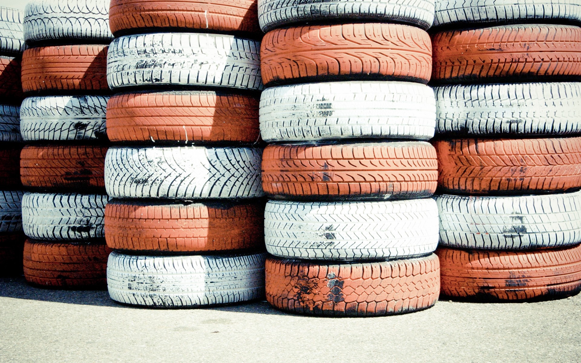 Stacks of orange and white tires HD Wallpaper