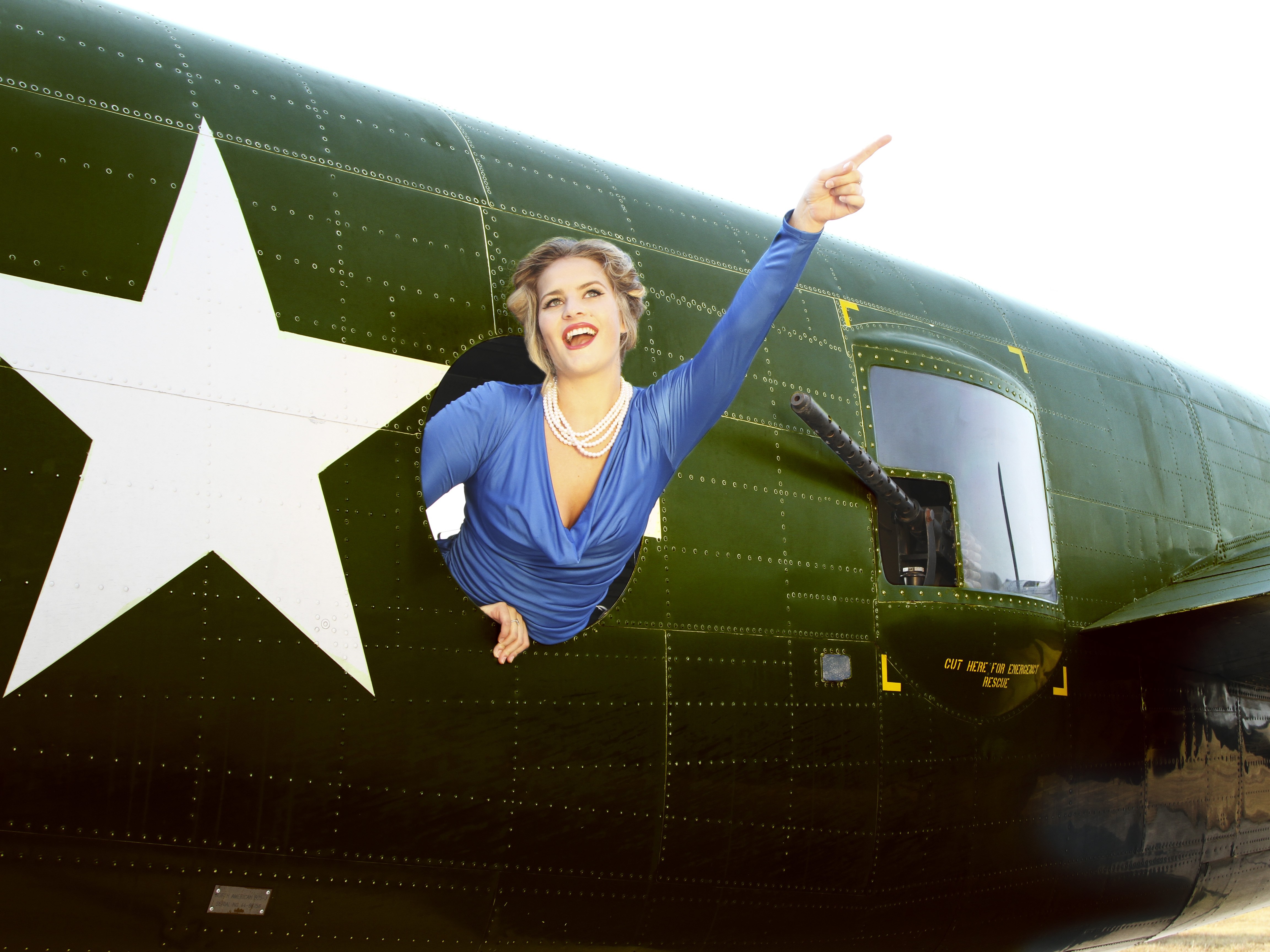 Woman in blue dress pointing from airplane window HD Wallpaper