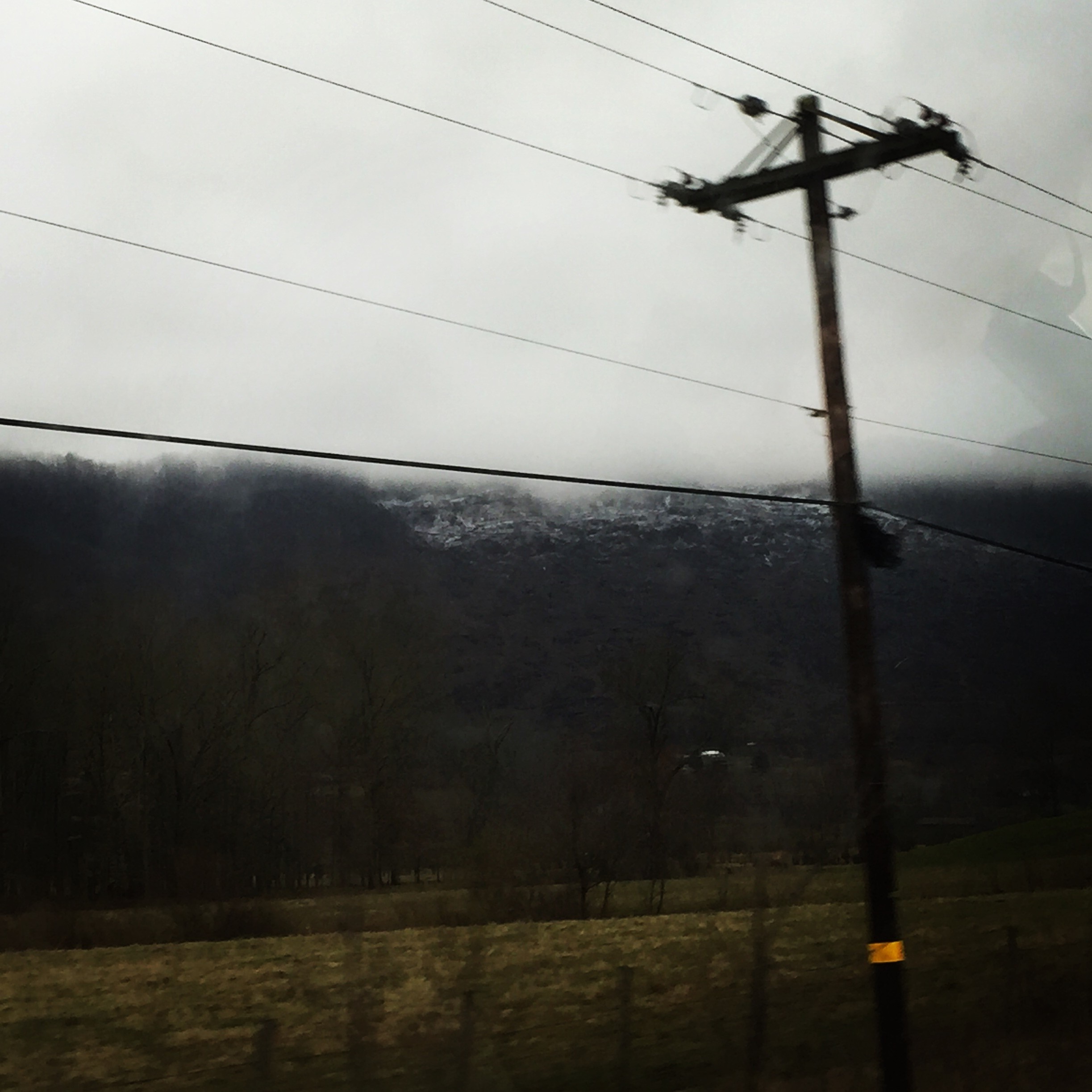 Overhead power line against a misty mountain landscape HD Wallpaper