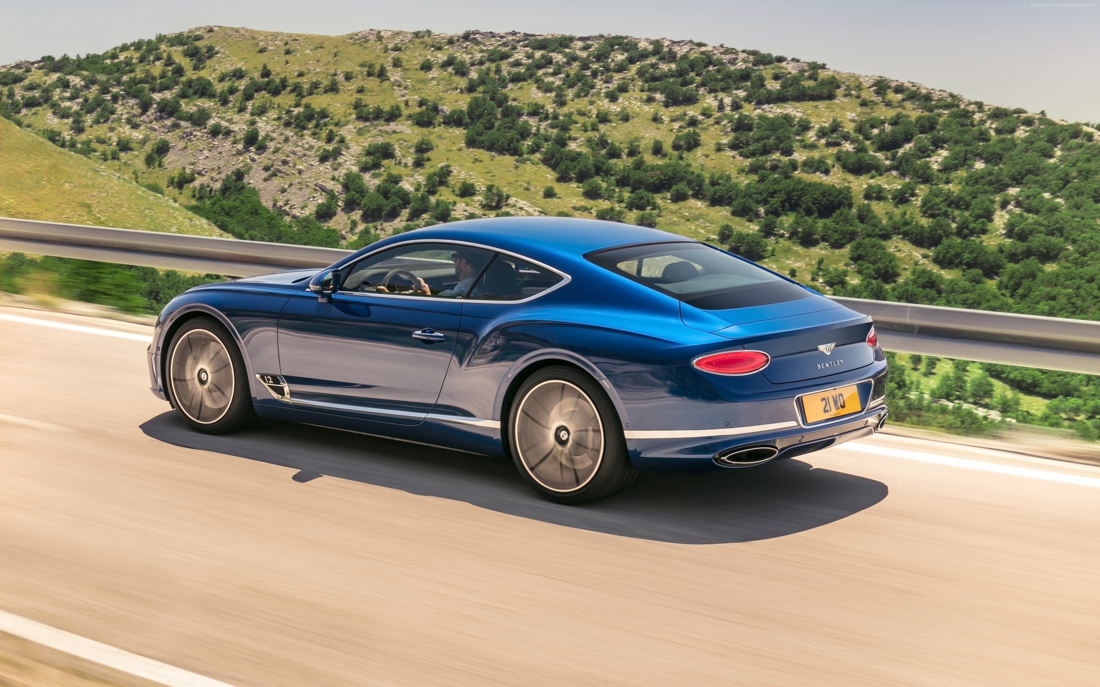 Blue Bentley Continental GT driving on a road HD Wallpaper
