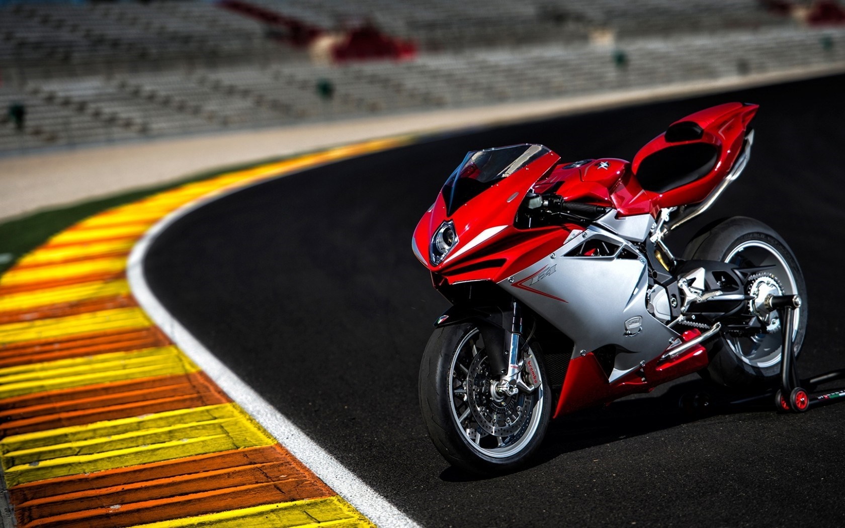 Red and silver MV Agusta motorcycle on a race track HD Wallpaper