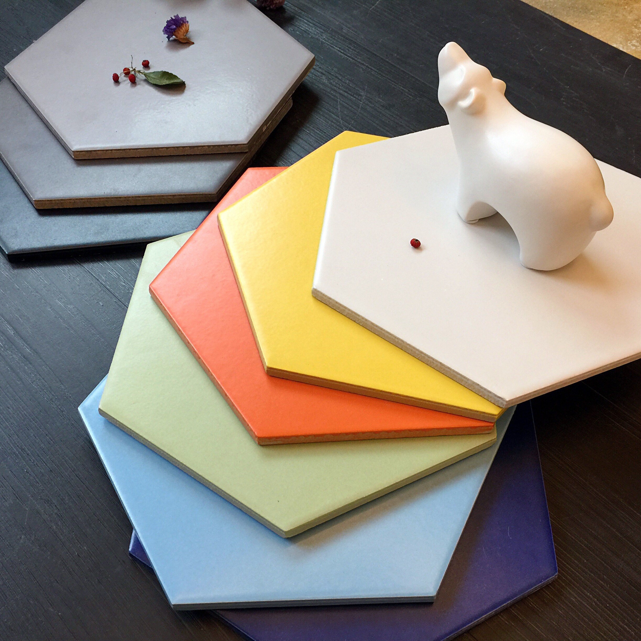 Hexagonal tiles with decorative elements and a ceramic bear figurine HD Wallpaper