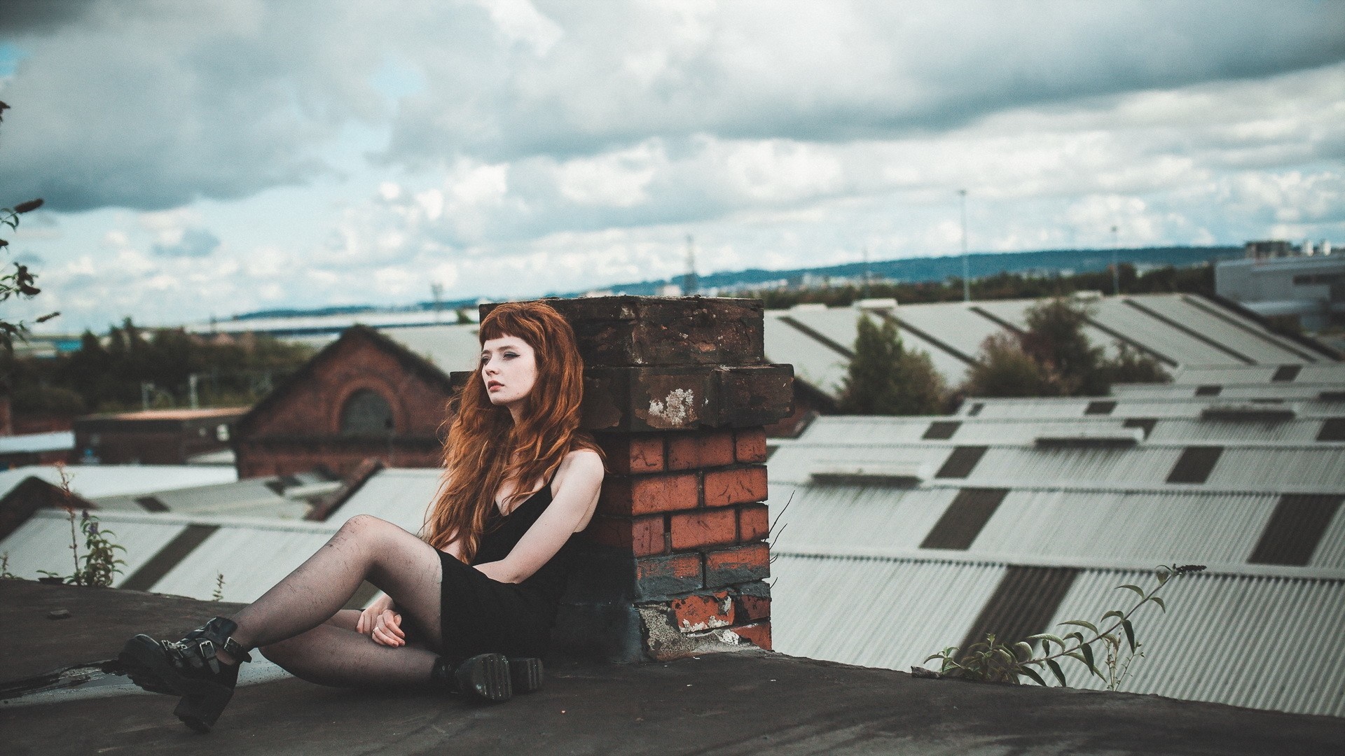Woman with red hair sitting on a rooftop HD Wallpaper