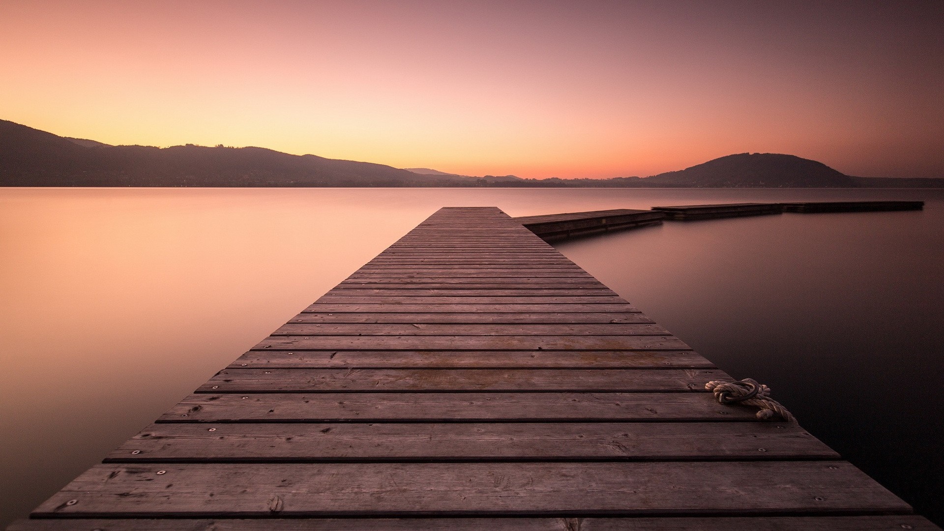 Wooden pier on a calm lake at sunset HD Wallpaper