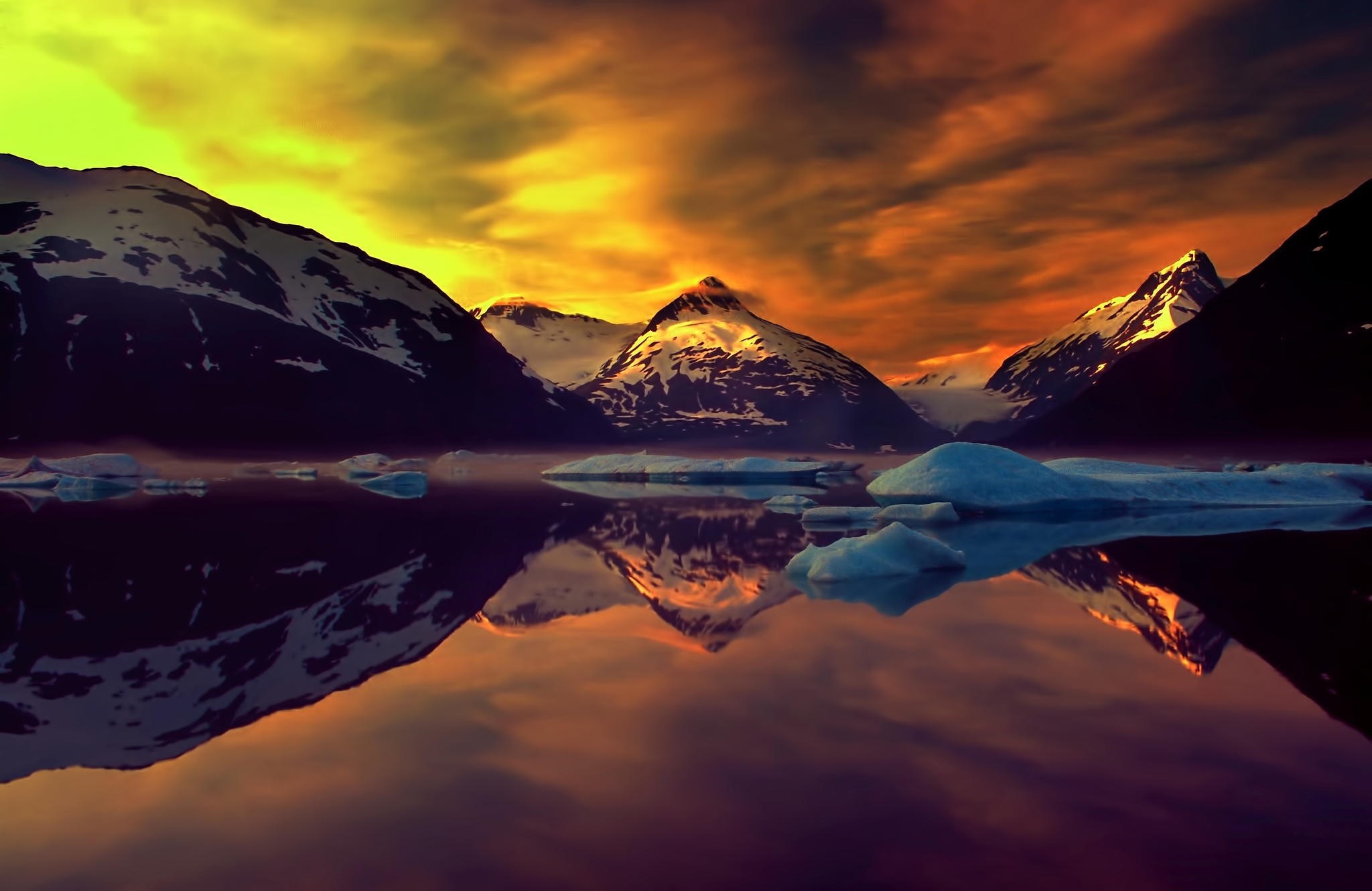 Snow-capped mountains reflected in a lake at sunset HD Wallpaper