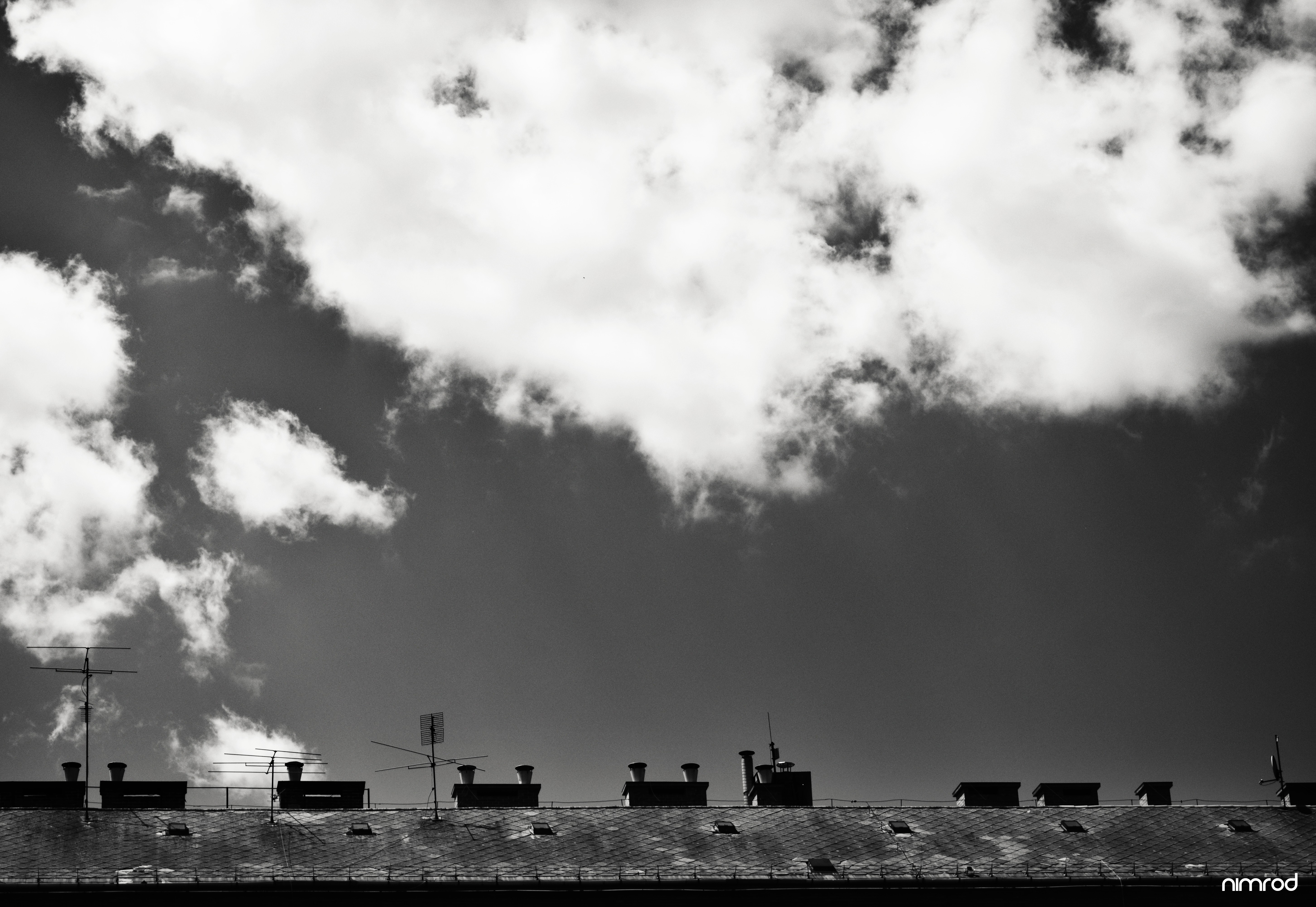 Rooftops and clouds in monochrome photography HD Wallpaper