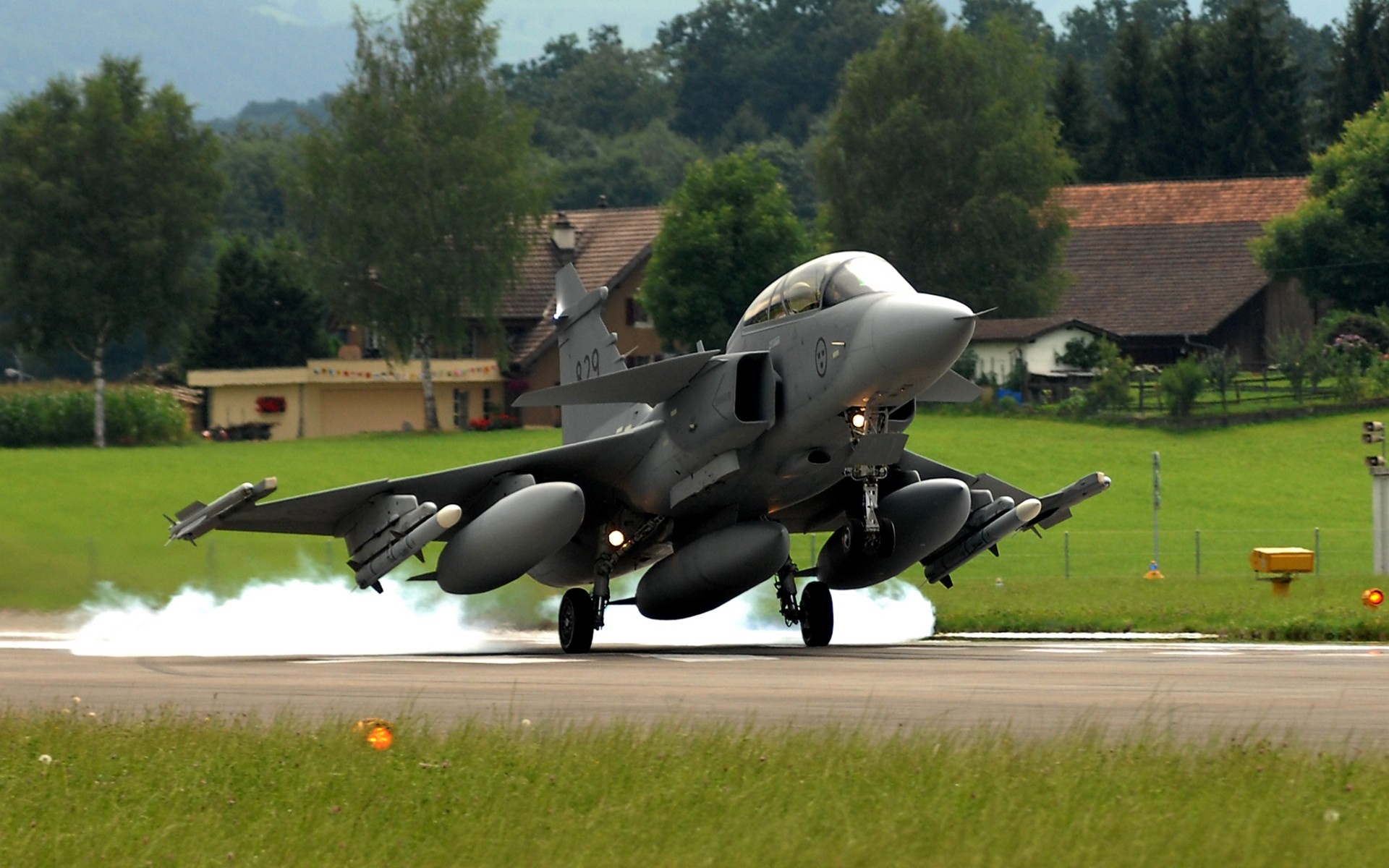 Saab JAS 39 Gripen fighter jet landing on runway HD Wallpaper