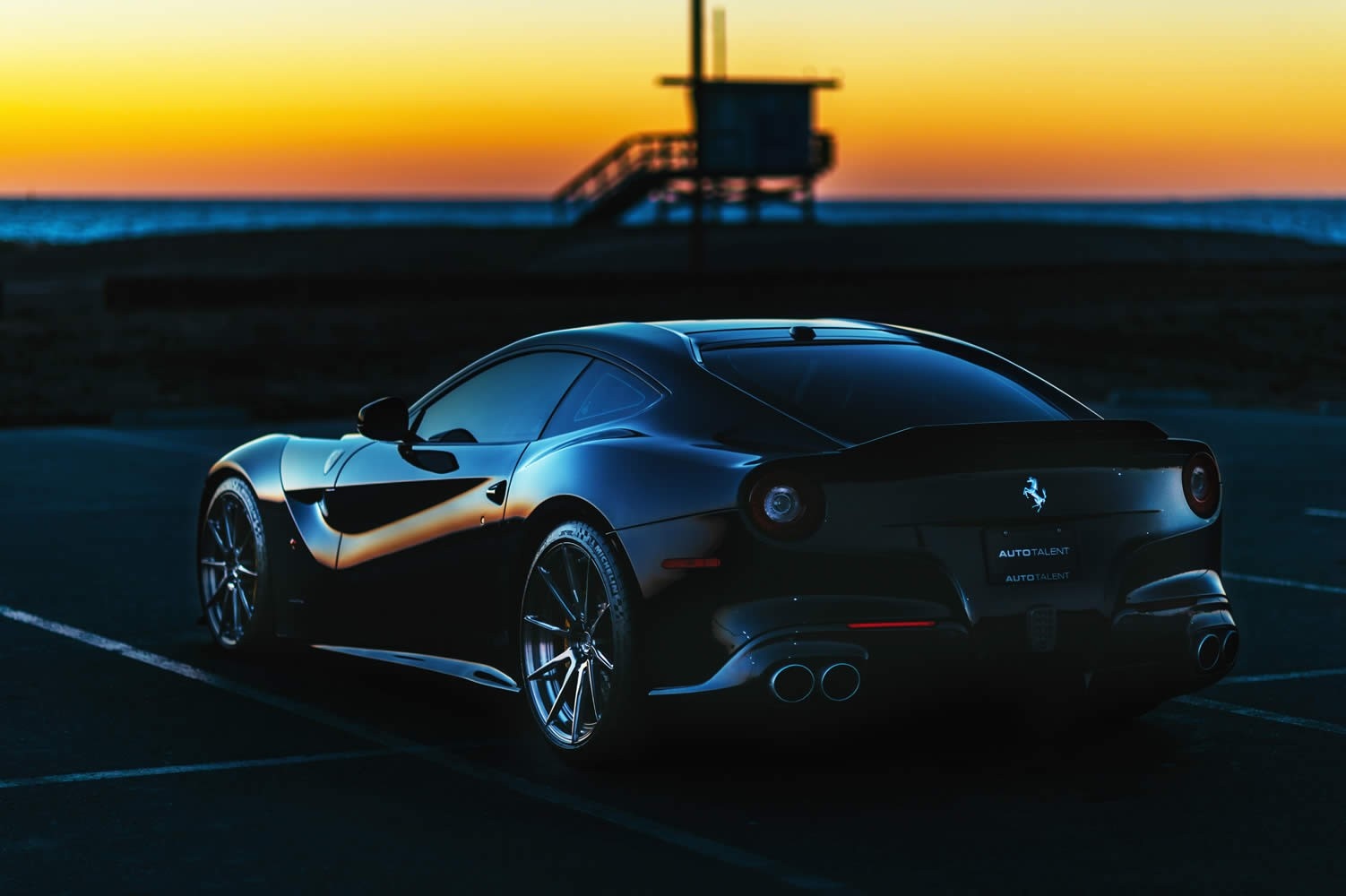 Black Ferrari parked by the beach at sunset HD Wallpaper