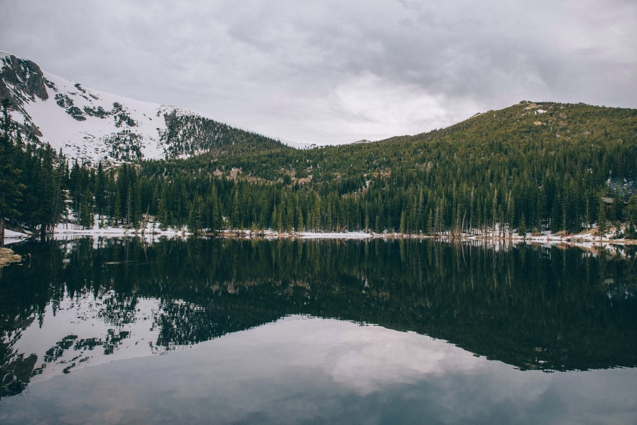 Snowy Mountain Range Reflected in a Calm Lake HD Wallpaper
