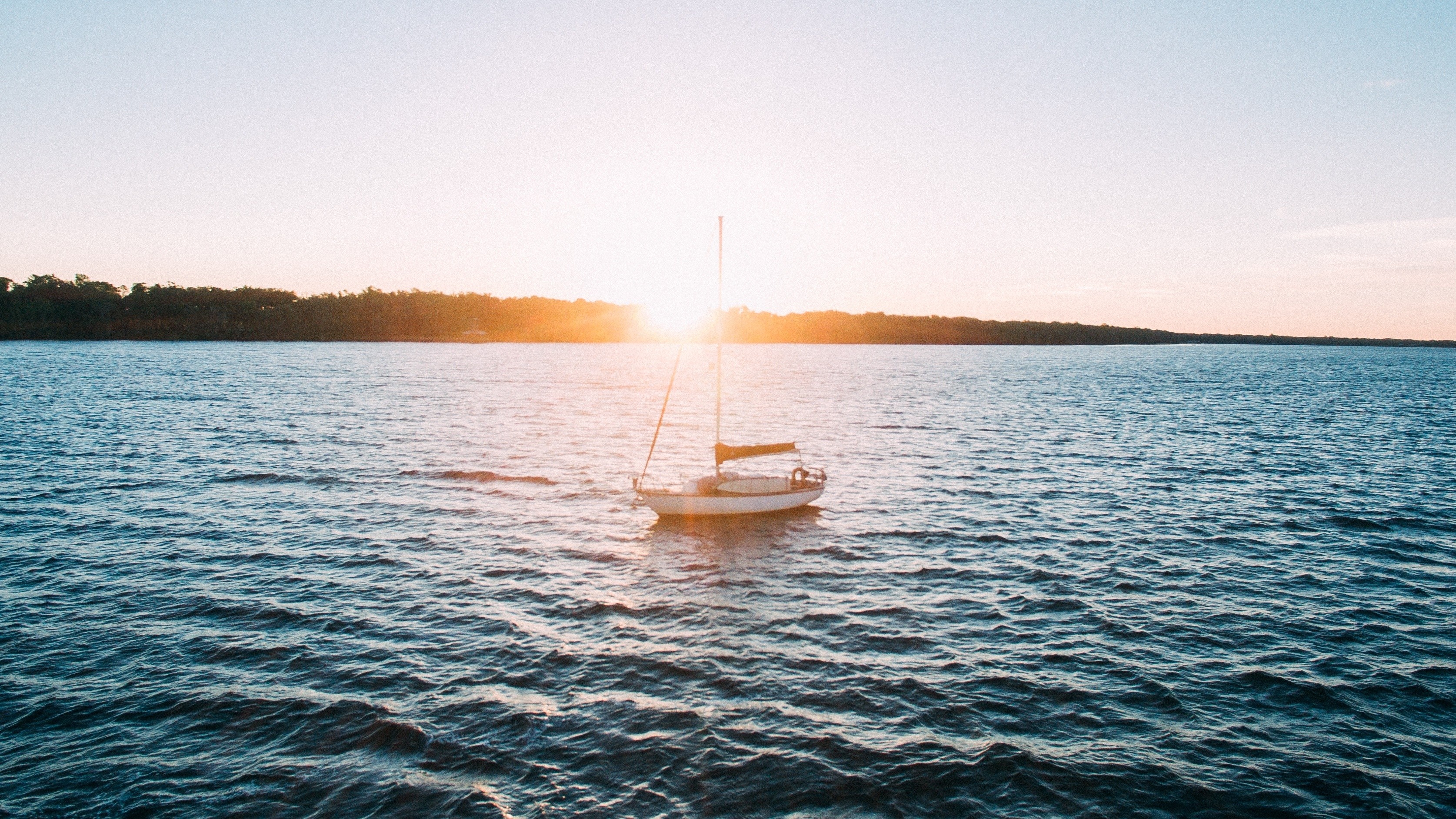 Sailboat on the water at sunset HD Wallpaper