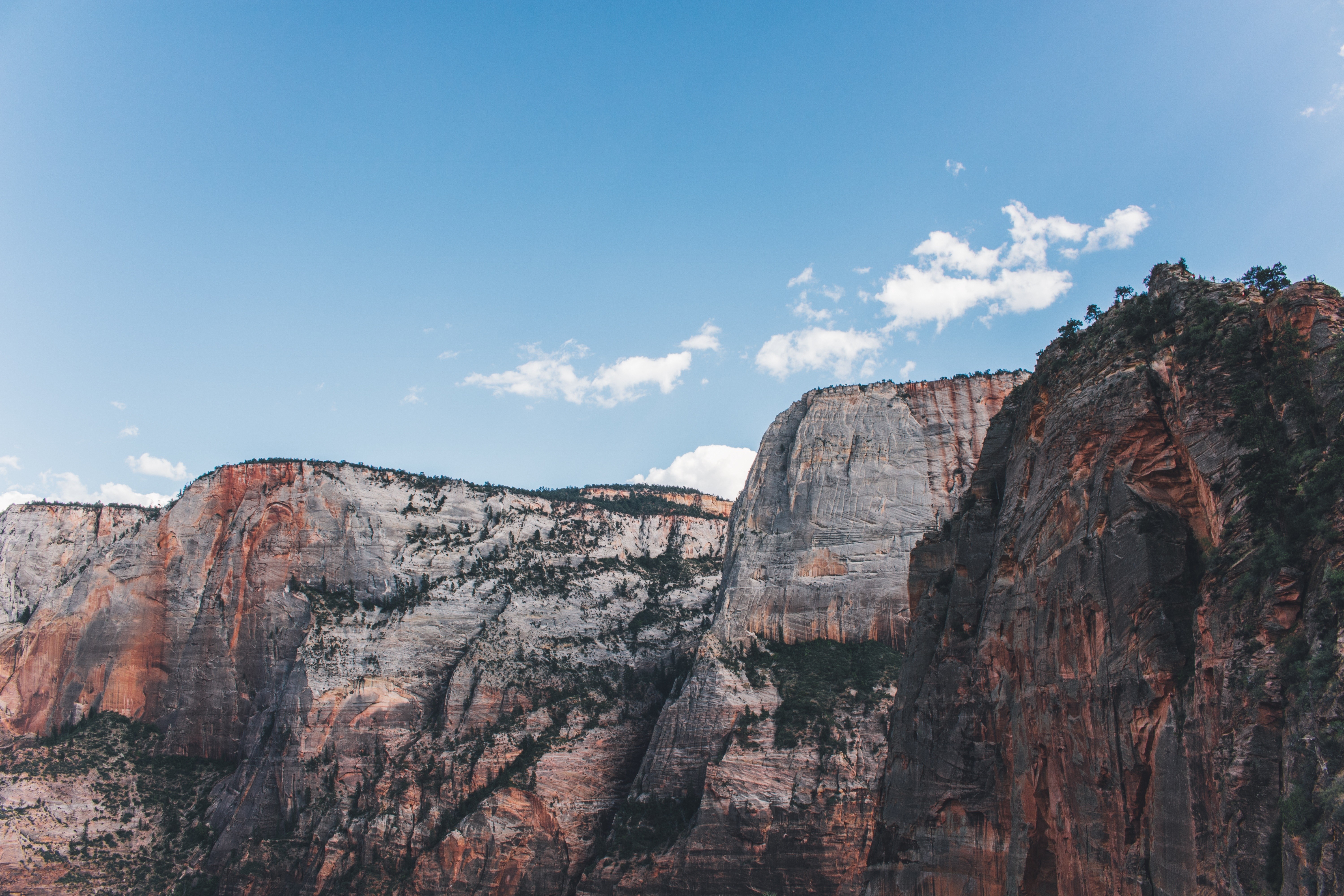 Majestic sandstone cliffs under a blue sky HD Wallpaper