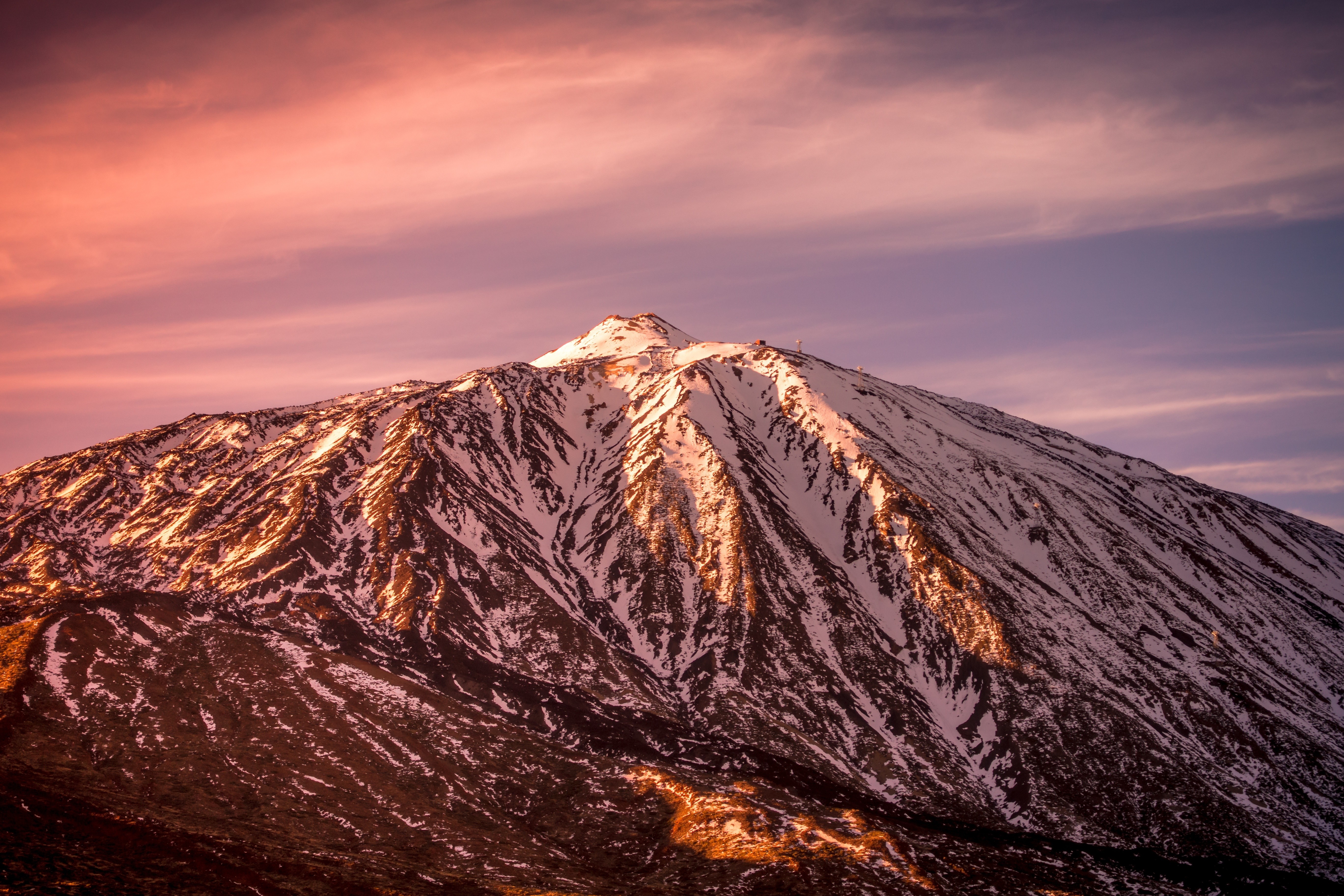 Snow-capped mountain peak at sunset HD Wallpaper