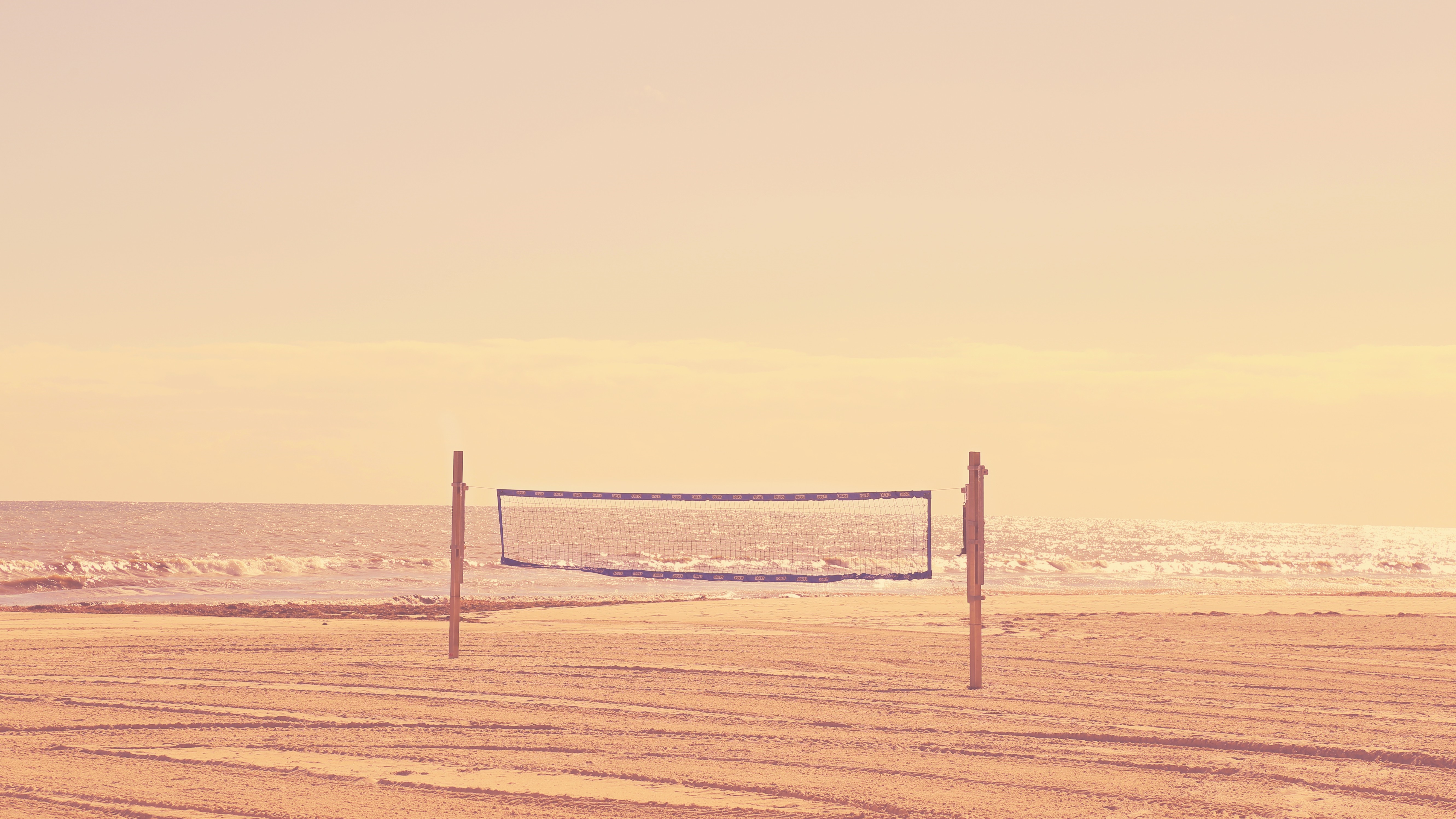 Beach volleyball net at sunrise or sunset HD Wallpaper