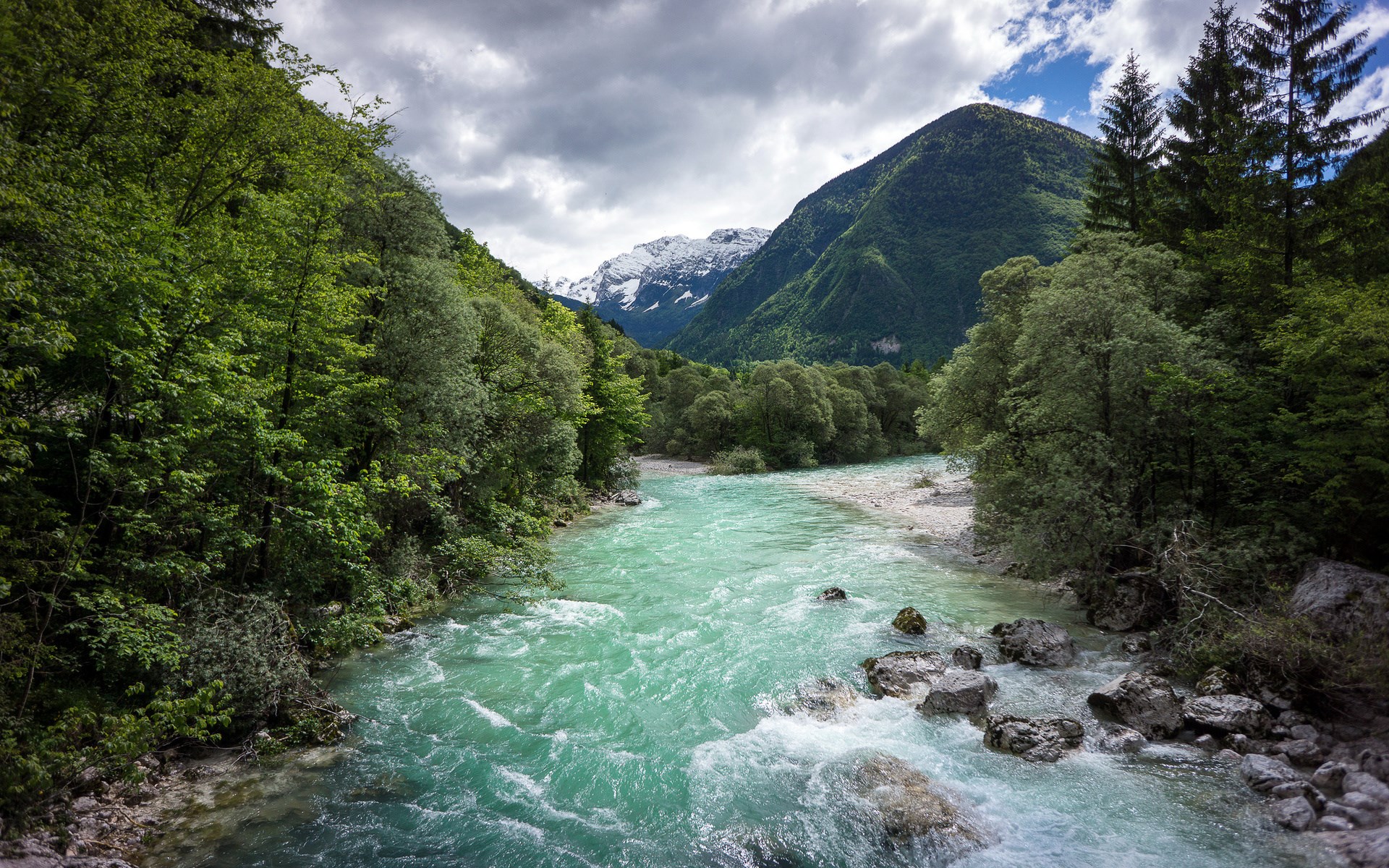 Turquoise river flowing through a green mountain valley HD Wallpaper